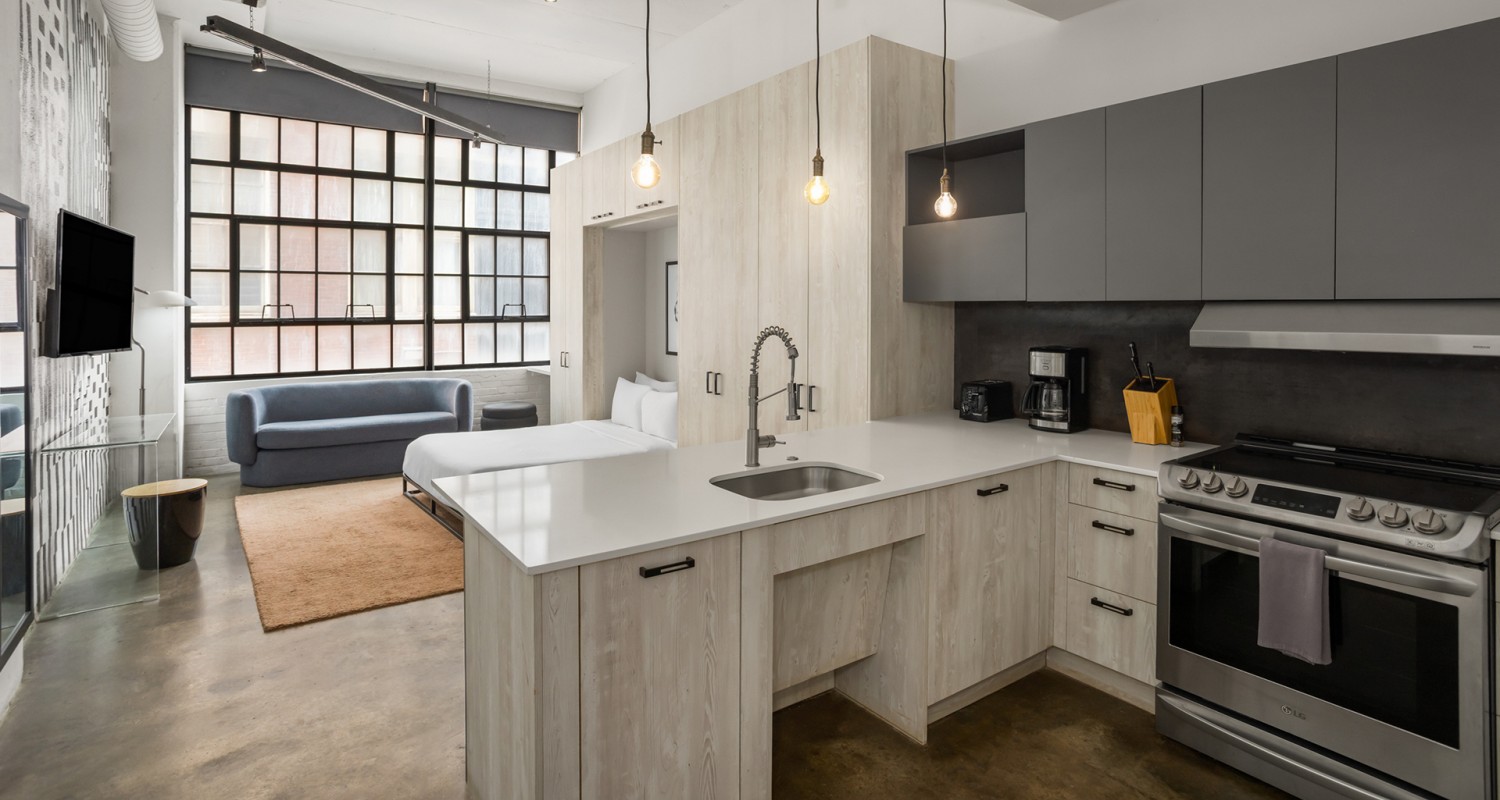 a kitchen with a sink and a bed