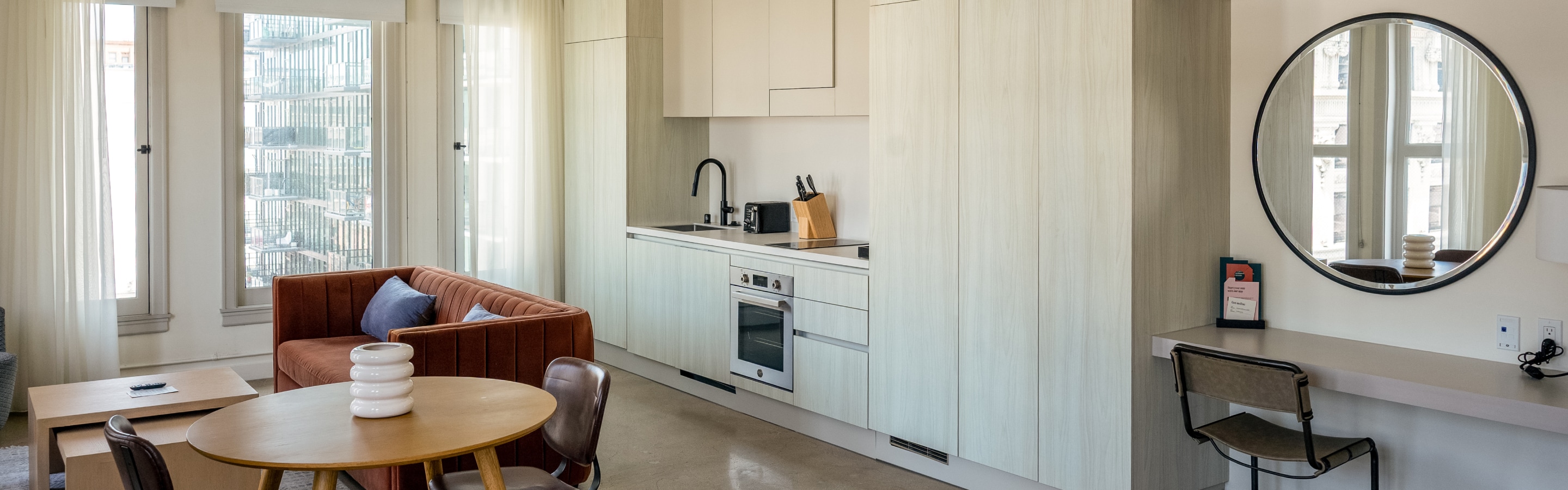 a kitchen with white cabinets and a table