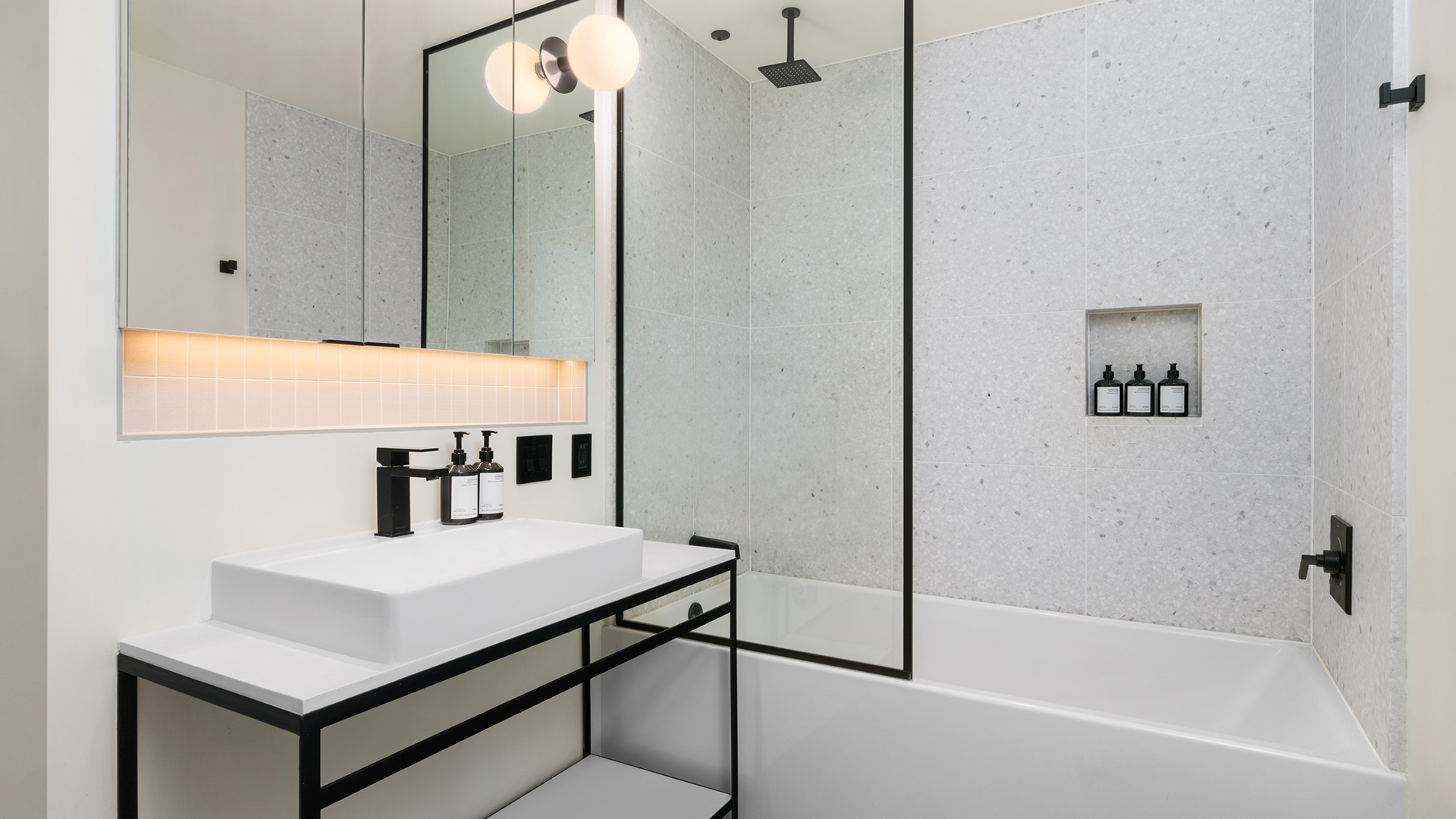 a bathroom with a shower and sink