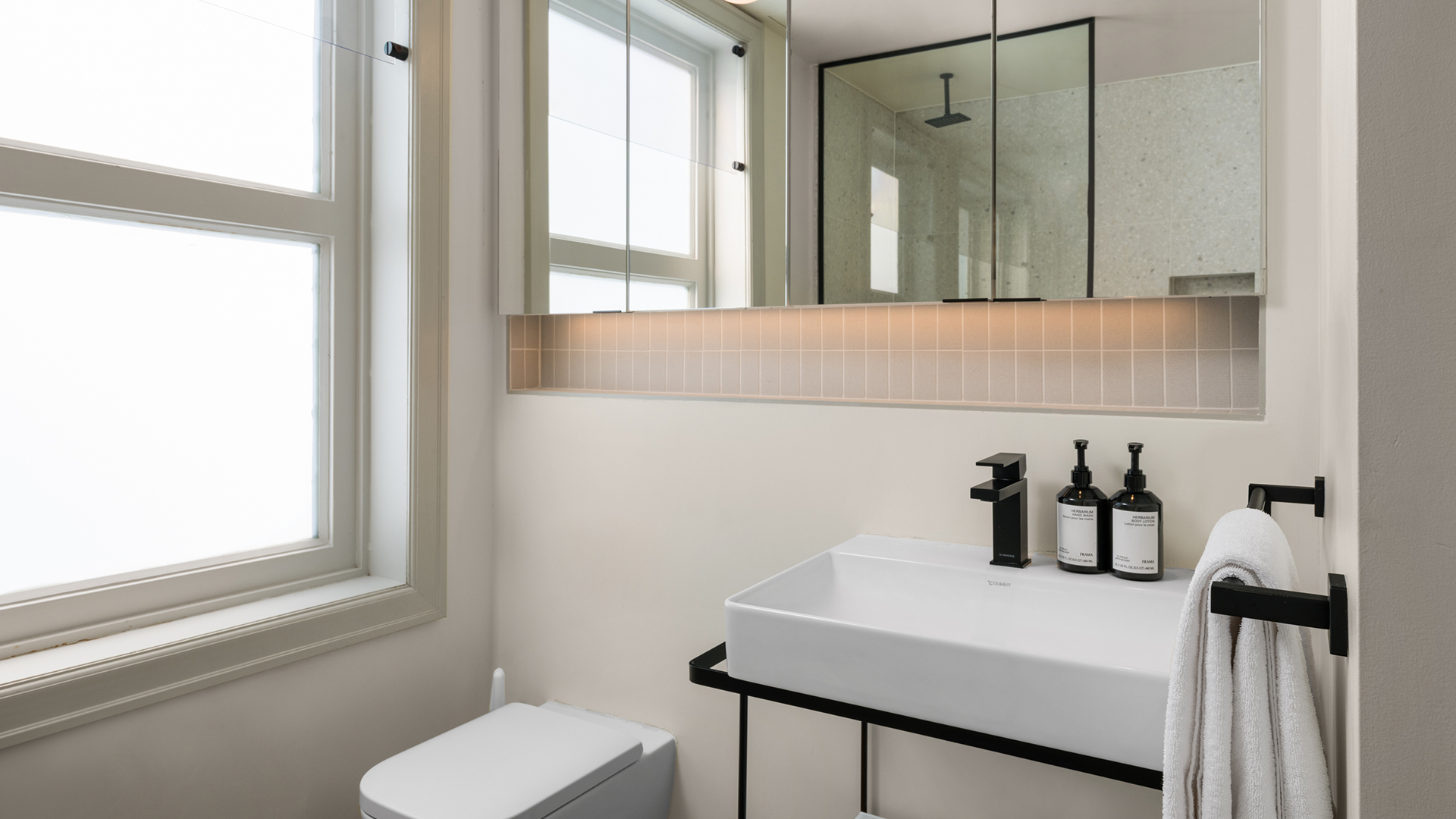 a bathroom with a mirror and sink