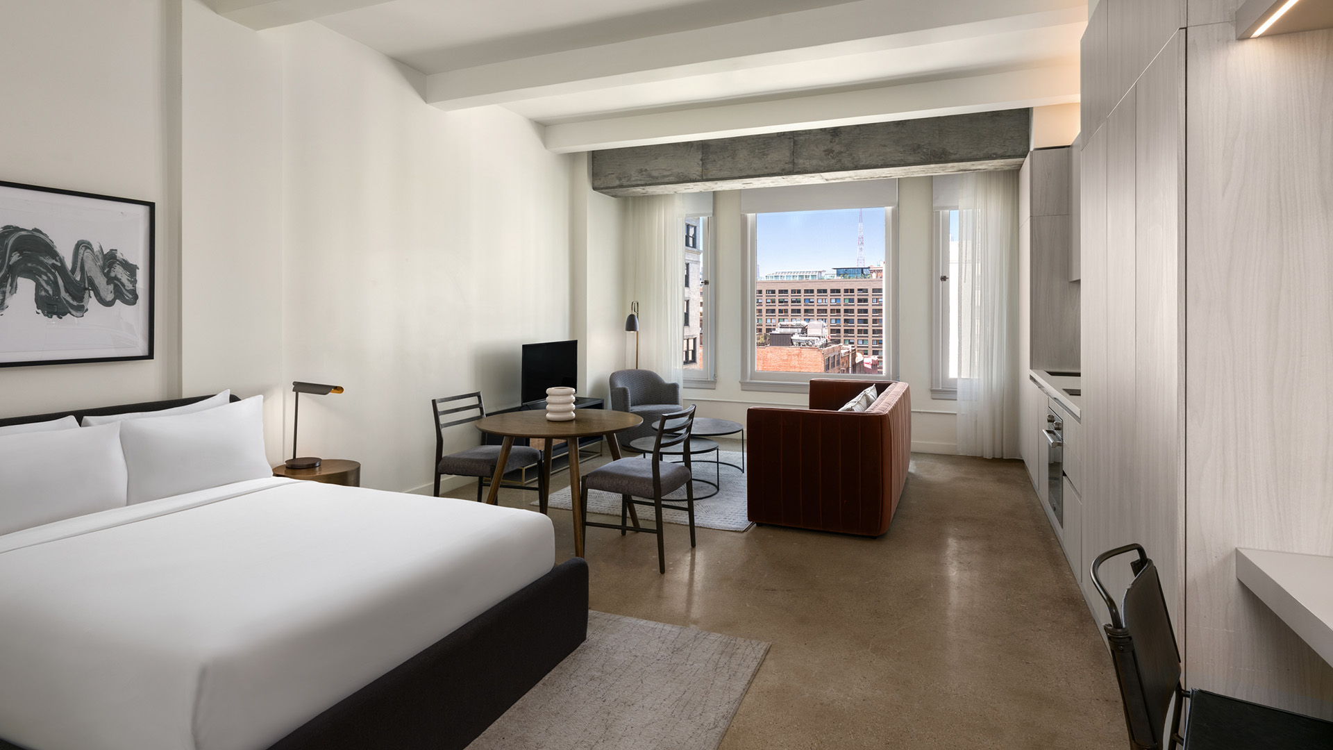 a room with a bed and a television