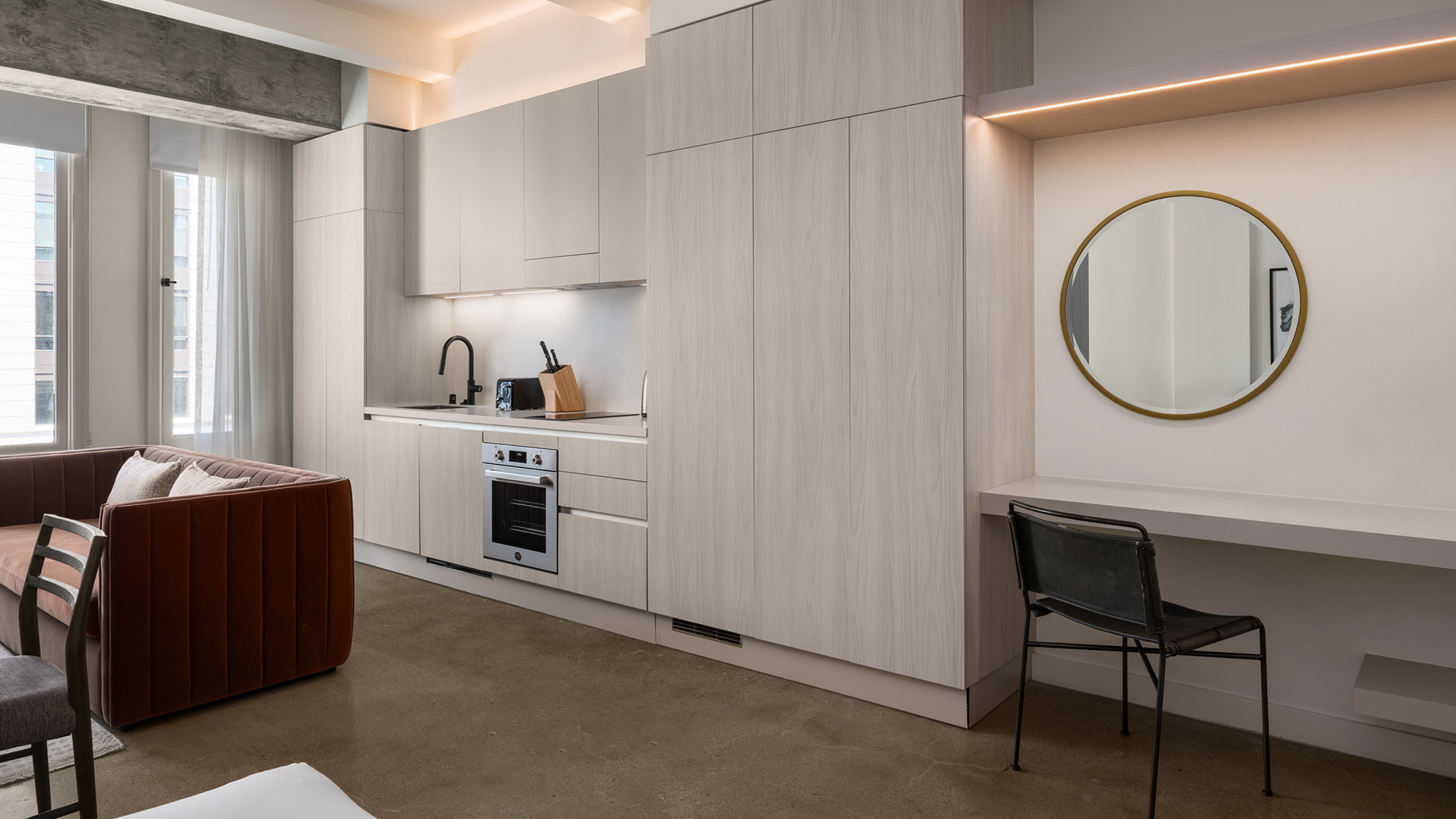 a kitchen with a sink and a chair