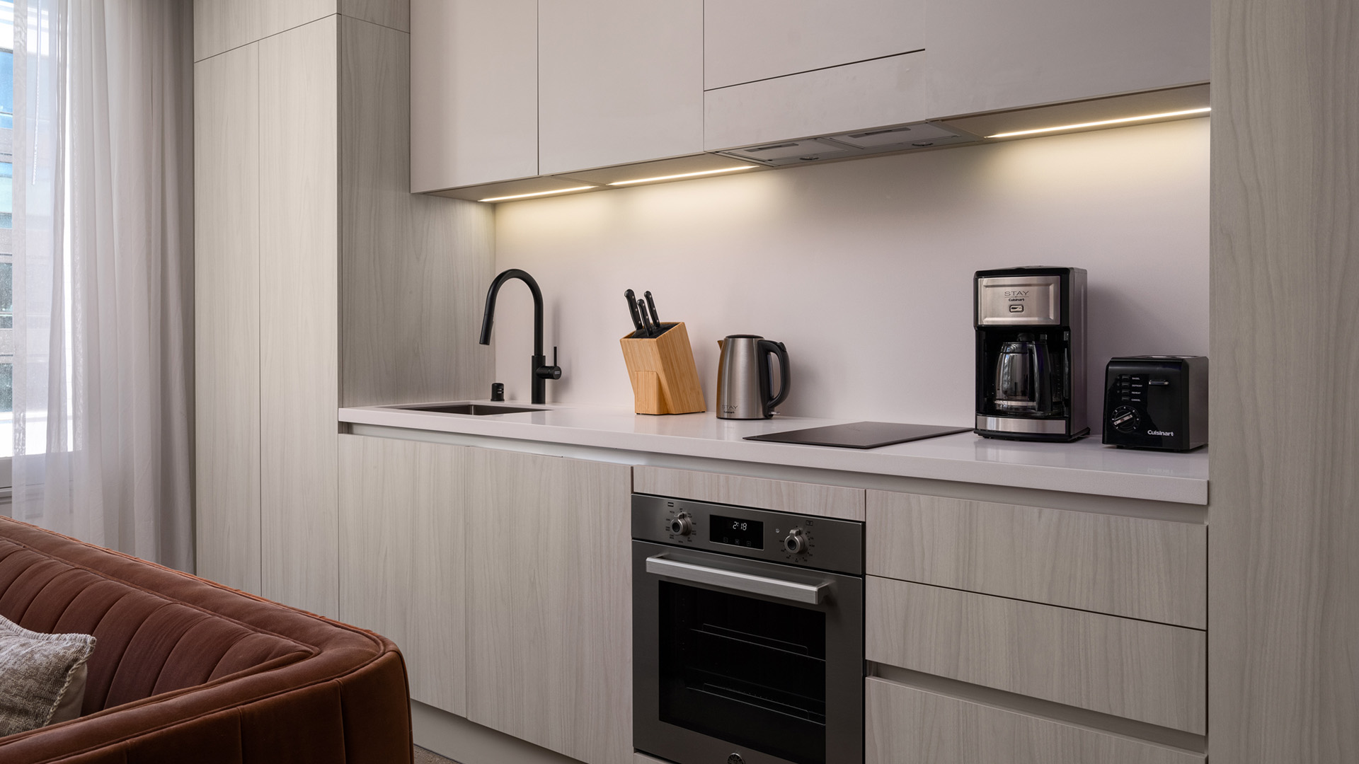 a kitchen with white cabinets and a counter top
