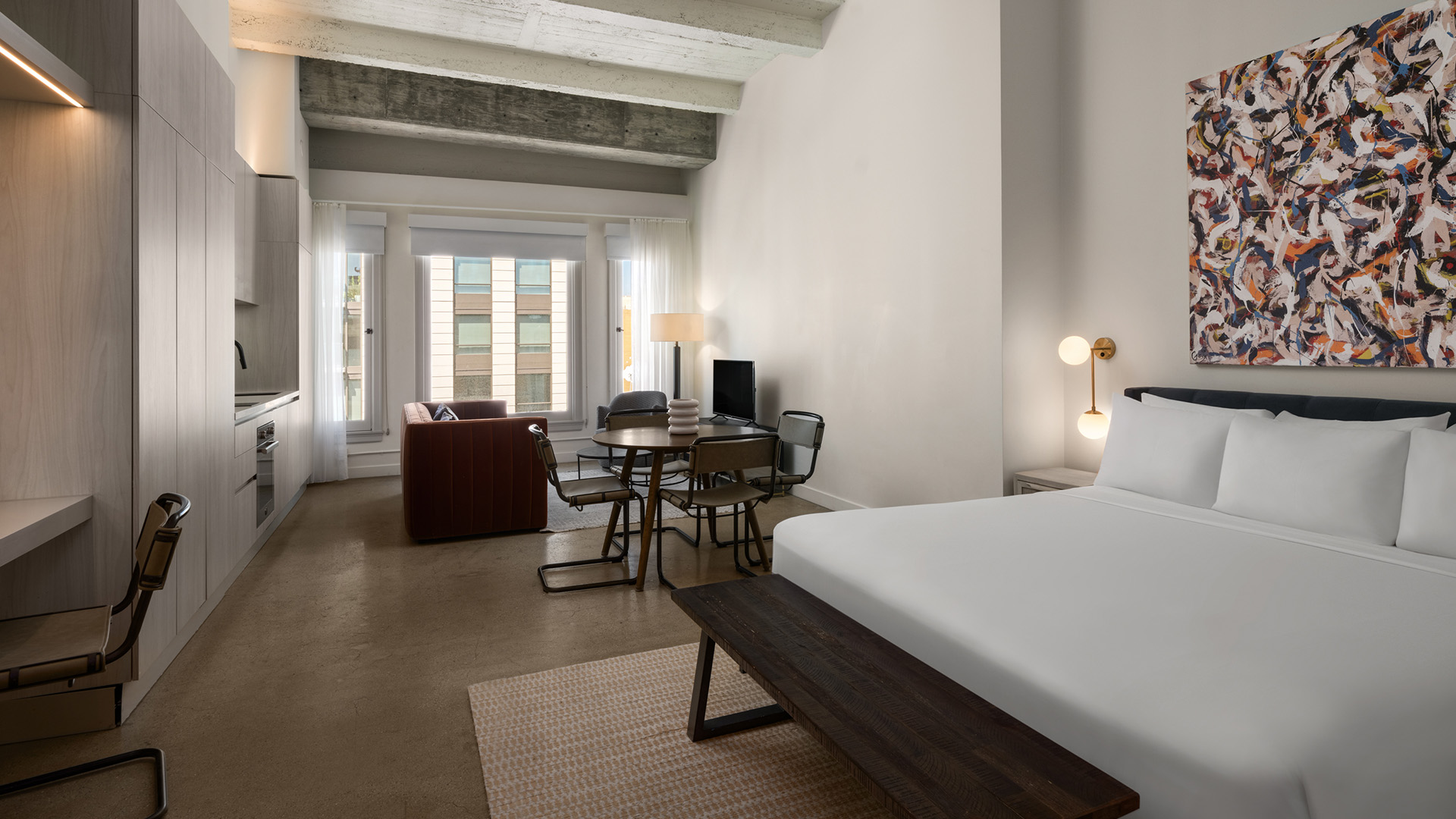 a room with a bed and a table and chairs