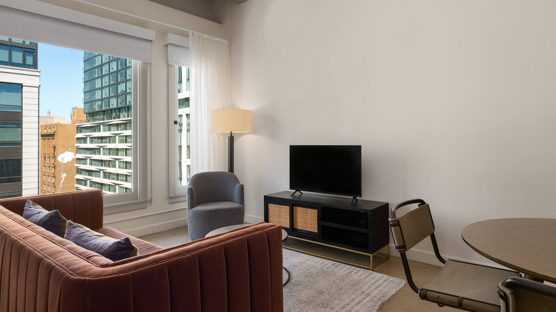 a living room with a tv and a chair