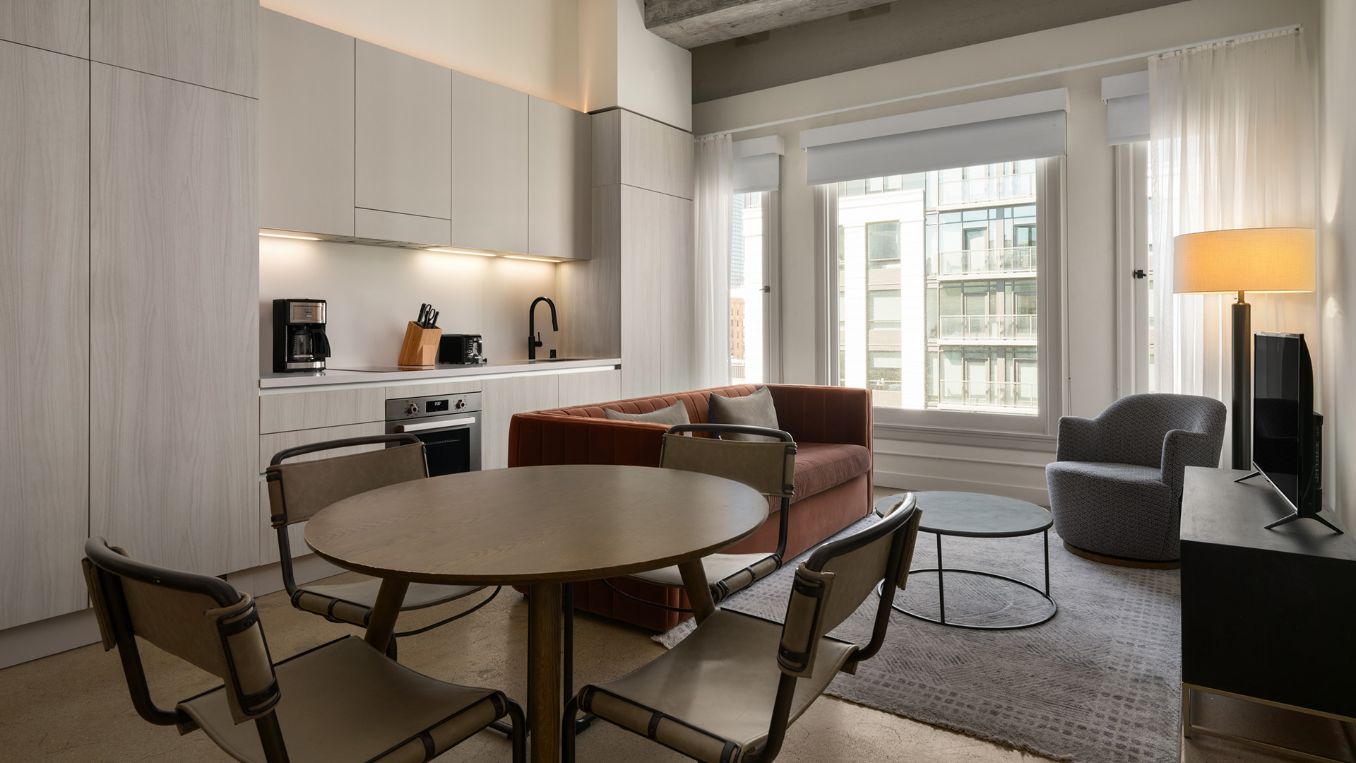 a living room with a couch and a kitchen