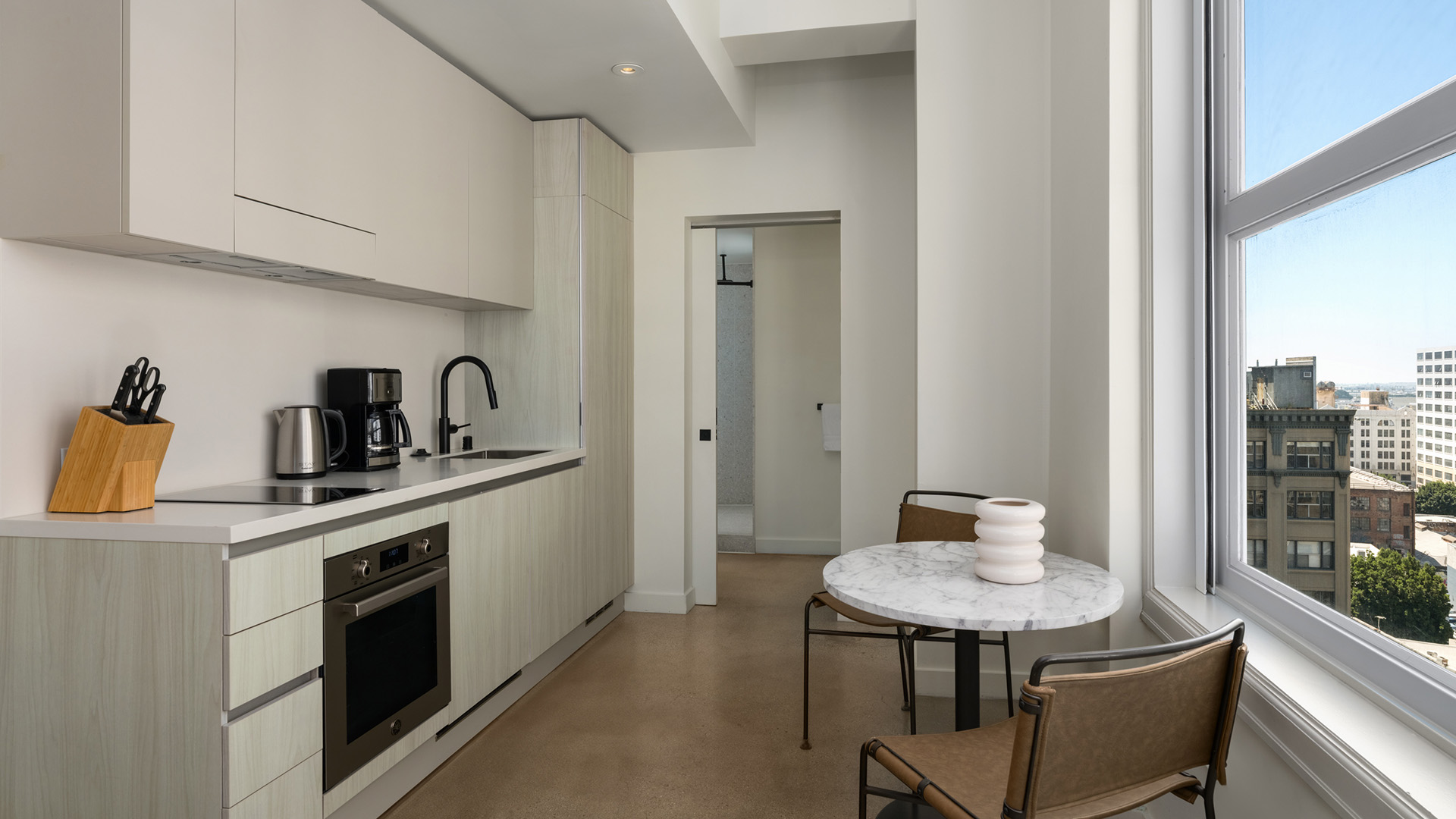 a kitchen with a table and chairs