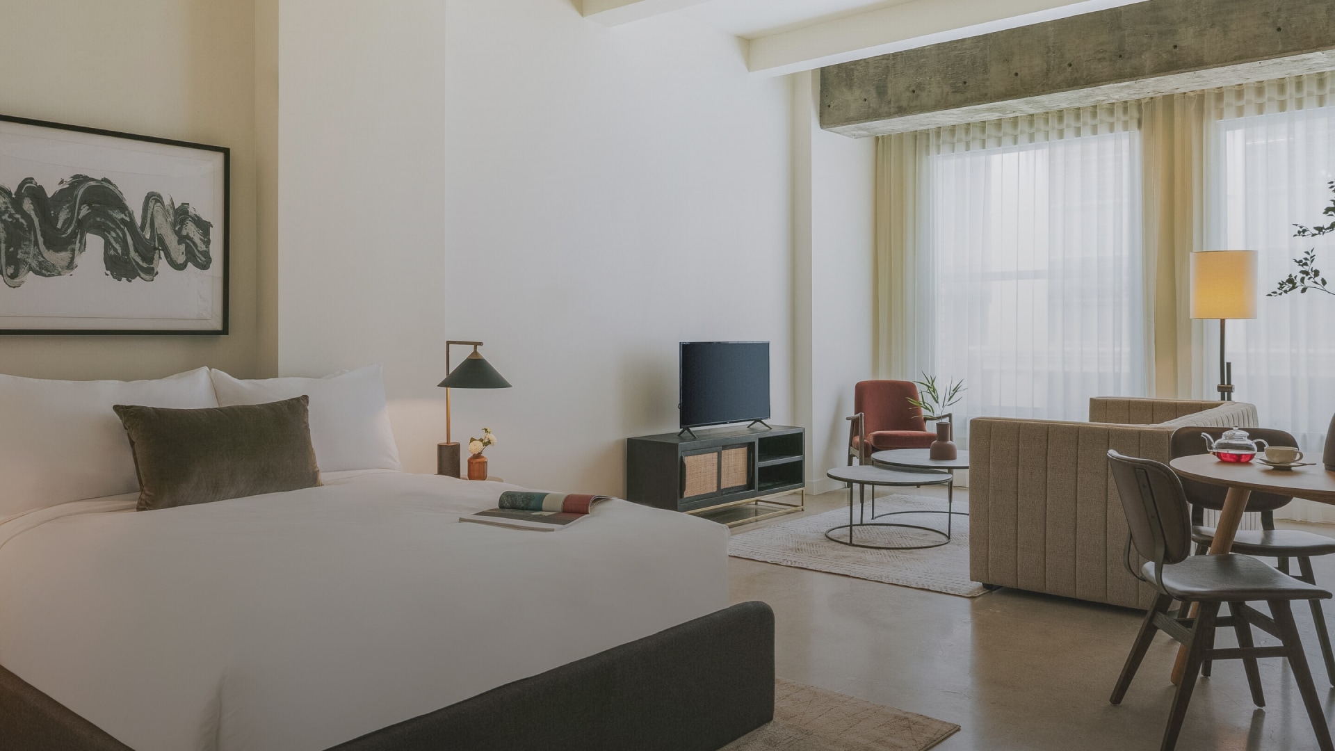 a bedroom with a bed and a tv