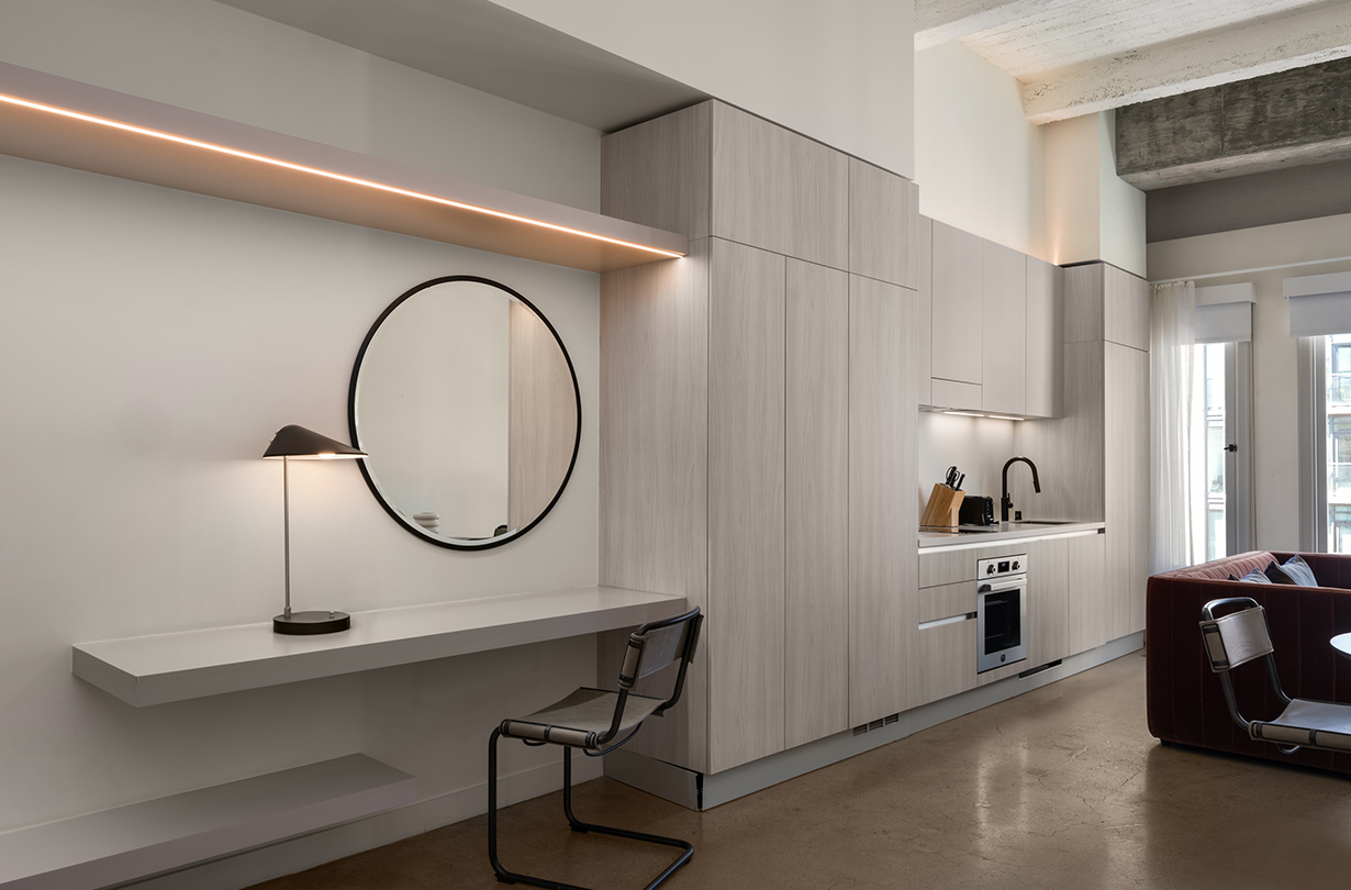 a kitchen with a round mirror and a table