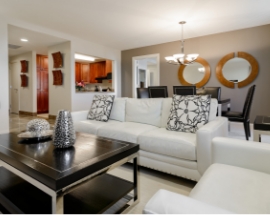 a living room with white couches and a black coffee table