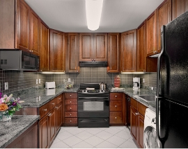 a kitchen with dark wood cabinets