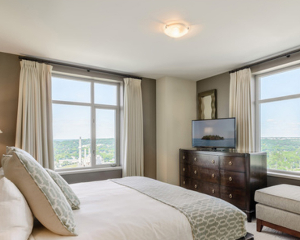 a bedroom with a television and a bed