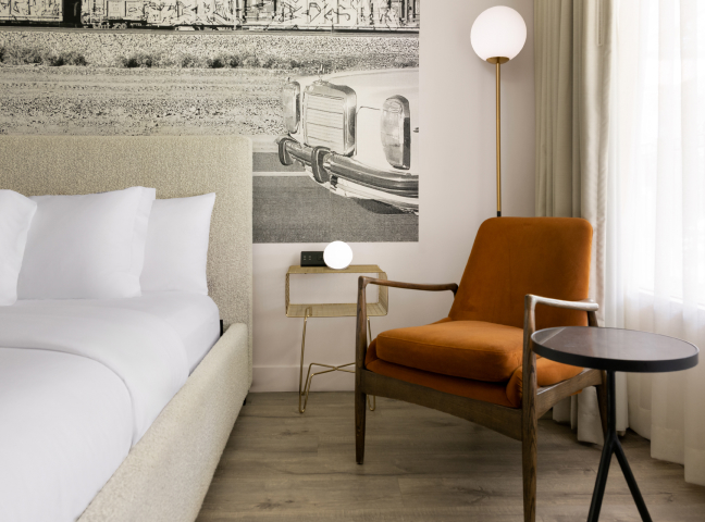 a chair next to a bed