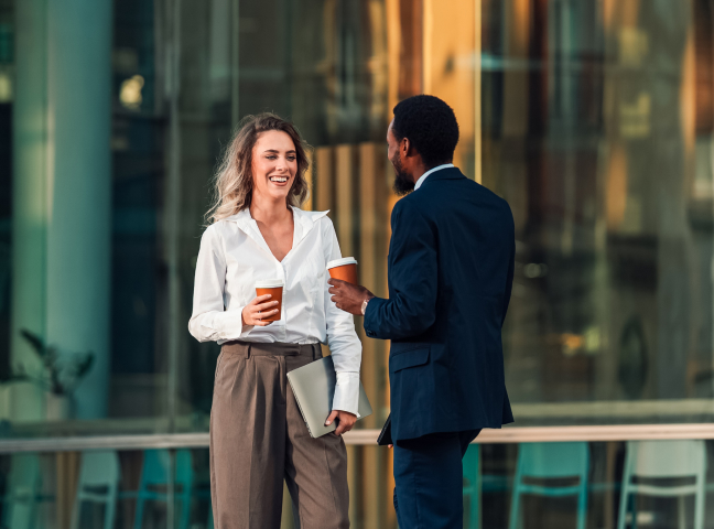 a man and woman talking and drinking coffee