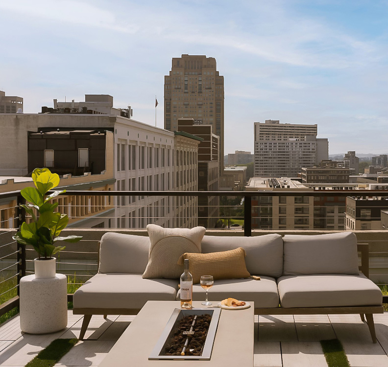 a couches on a rooftop overlooking a city