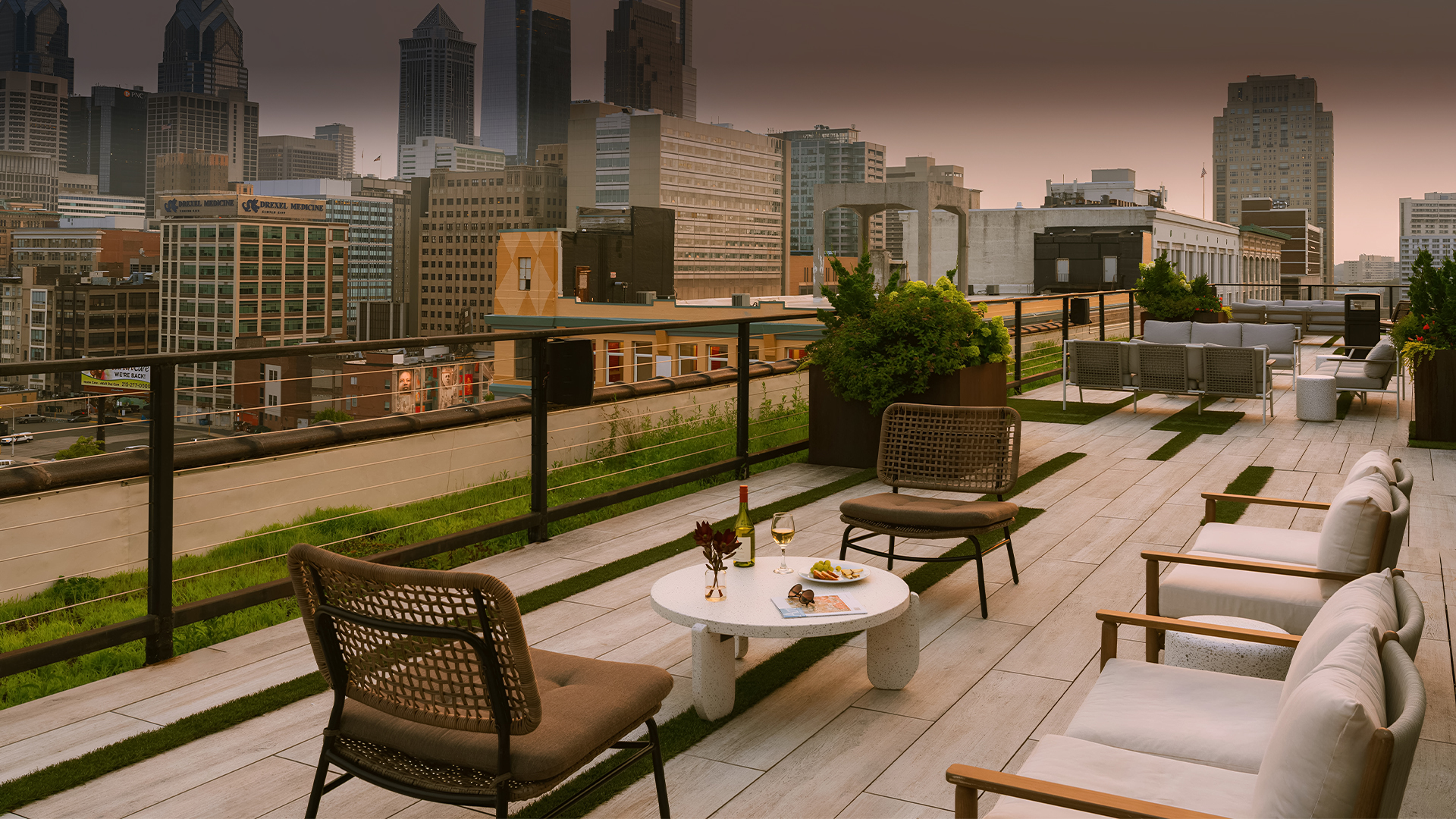 a patio with chairs and a table on a rooftop