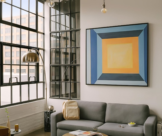 a living room with a large painting on the wall