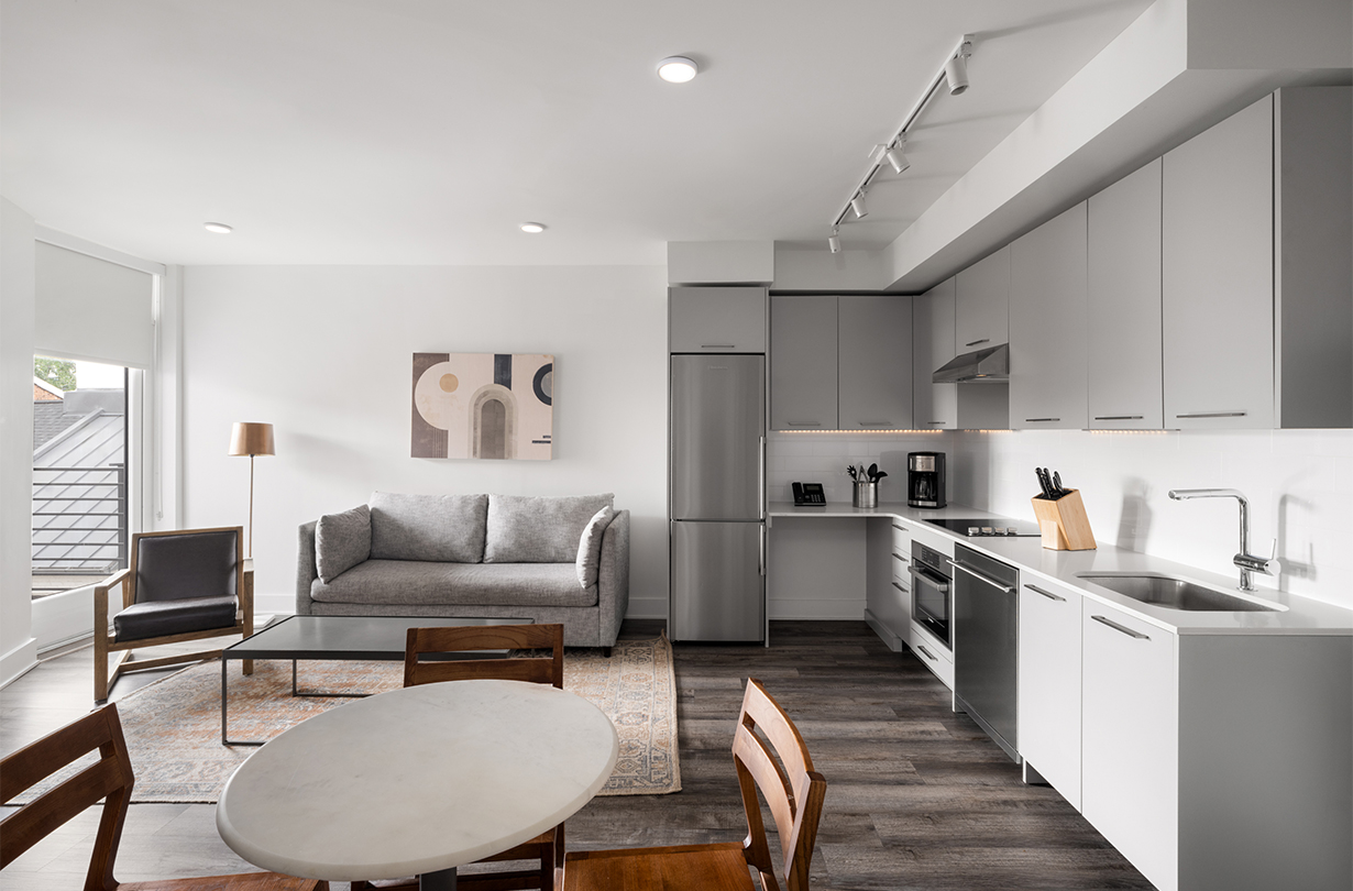 a kitchen and living room with a couch and a table