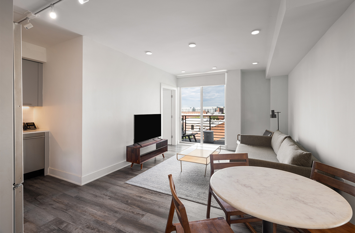 a living room with a table and chairs