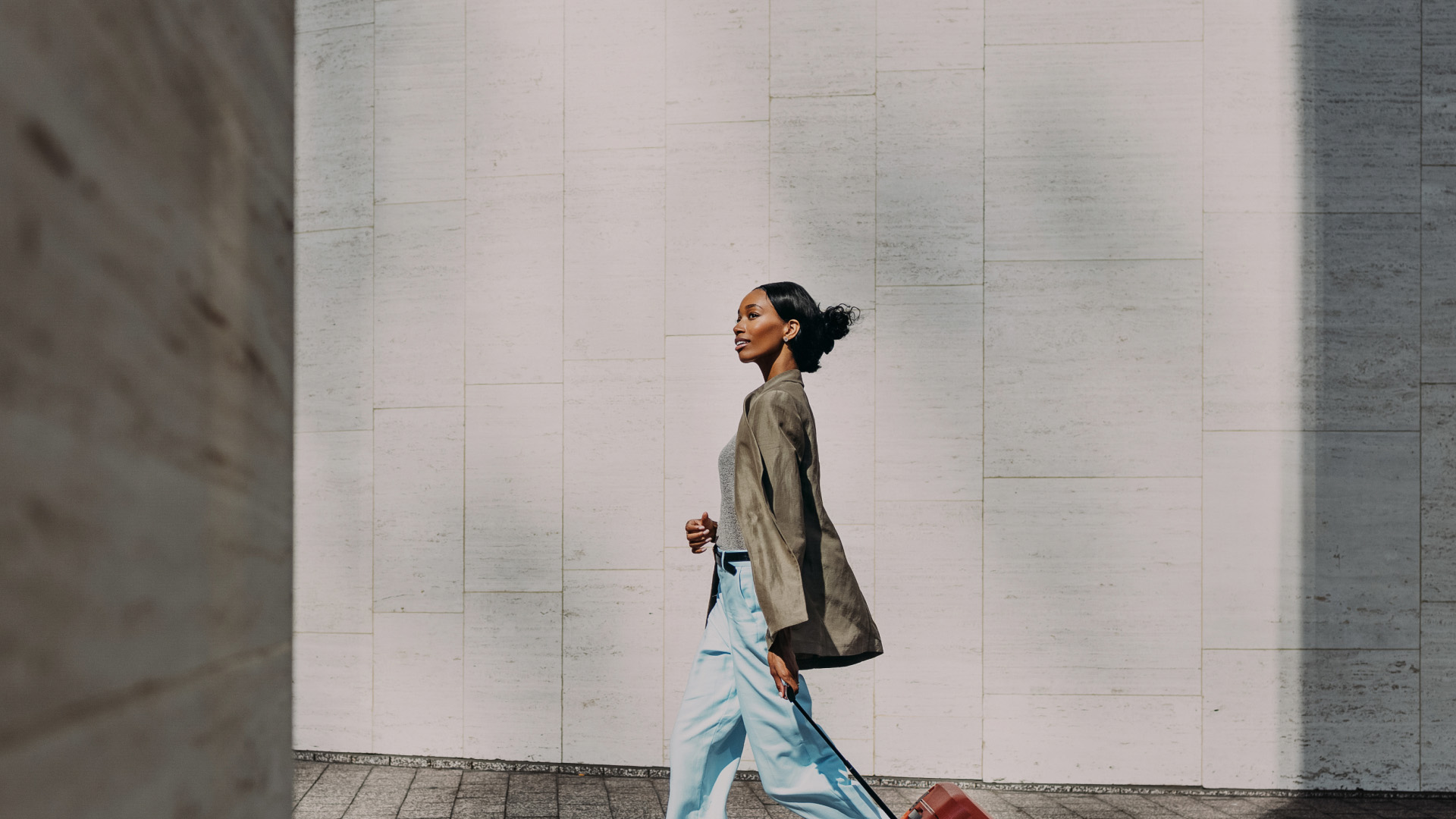 a woman walking with a suitcase