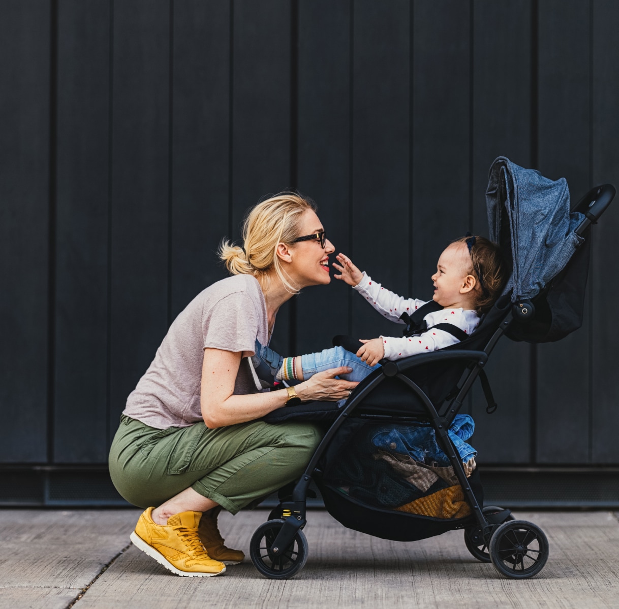 a woman sitting in a stroller with a baby