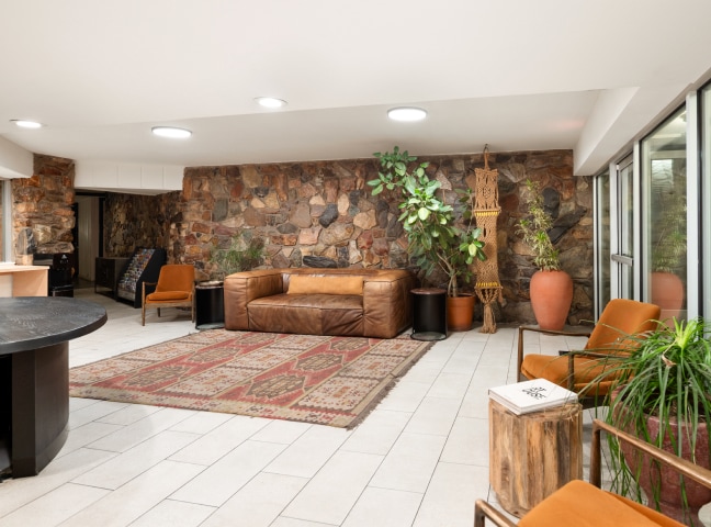 a room with a couch and chairs