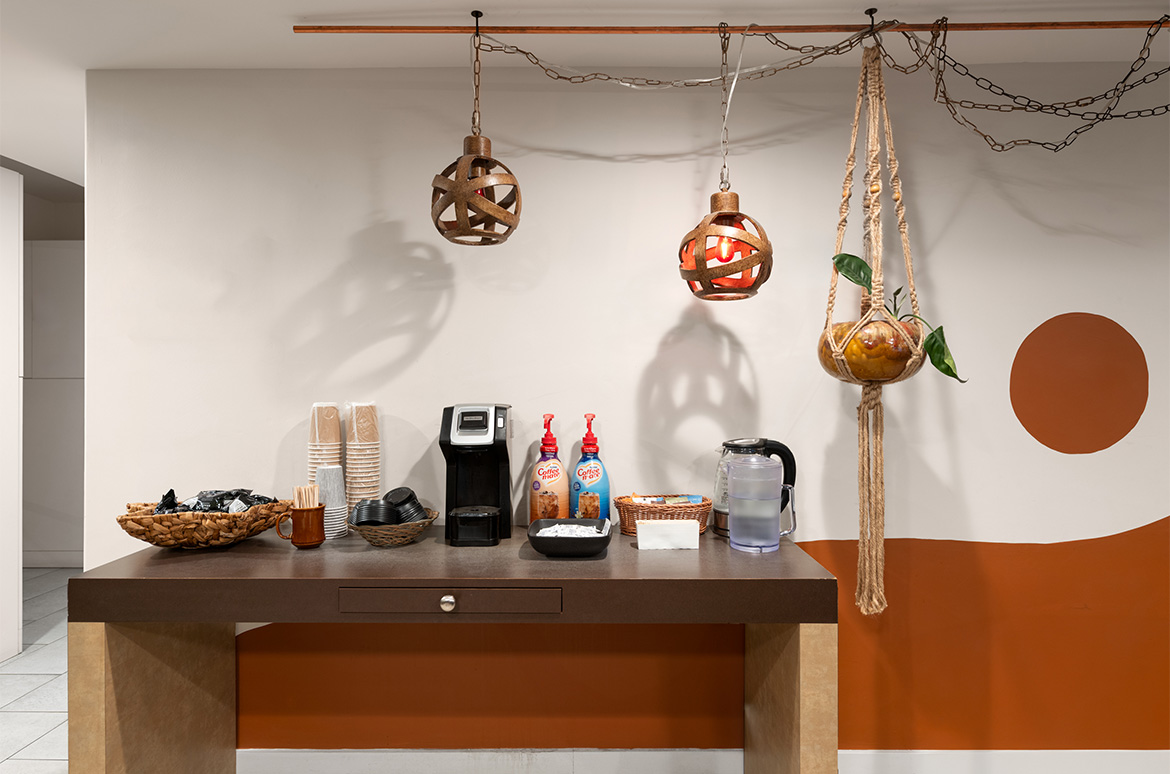 a counter with a coffee machine and objects on it