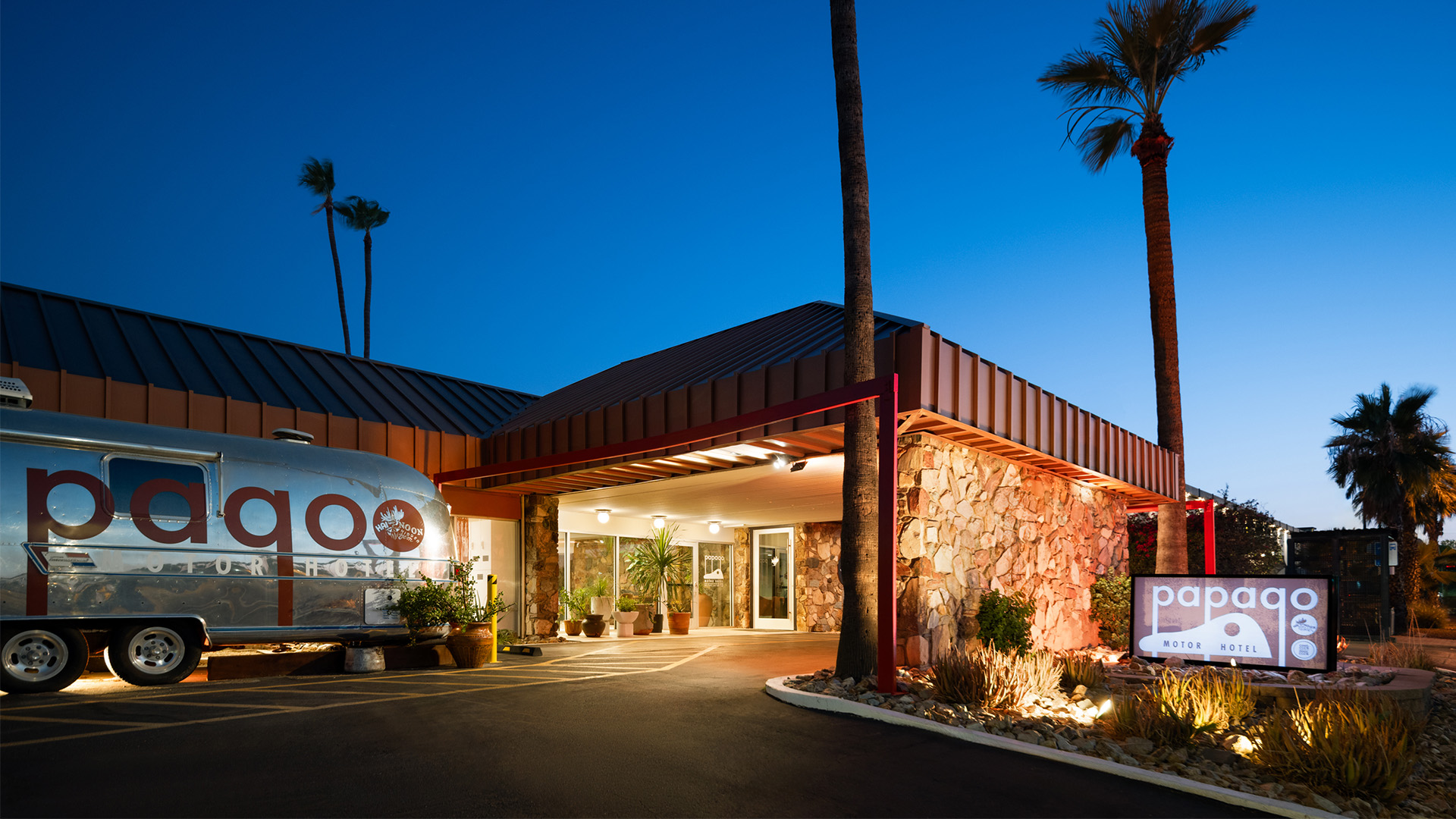 a building with palm trees and a round glass dome