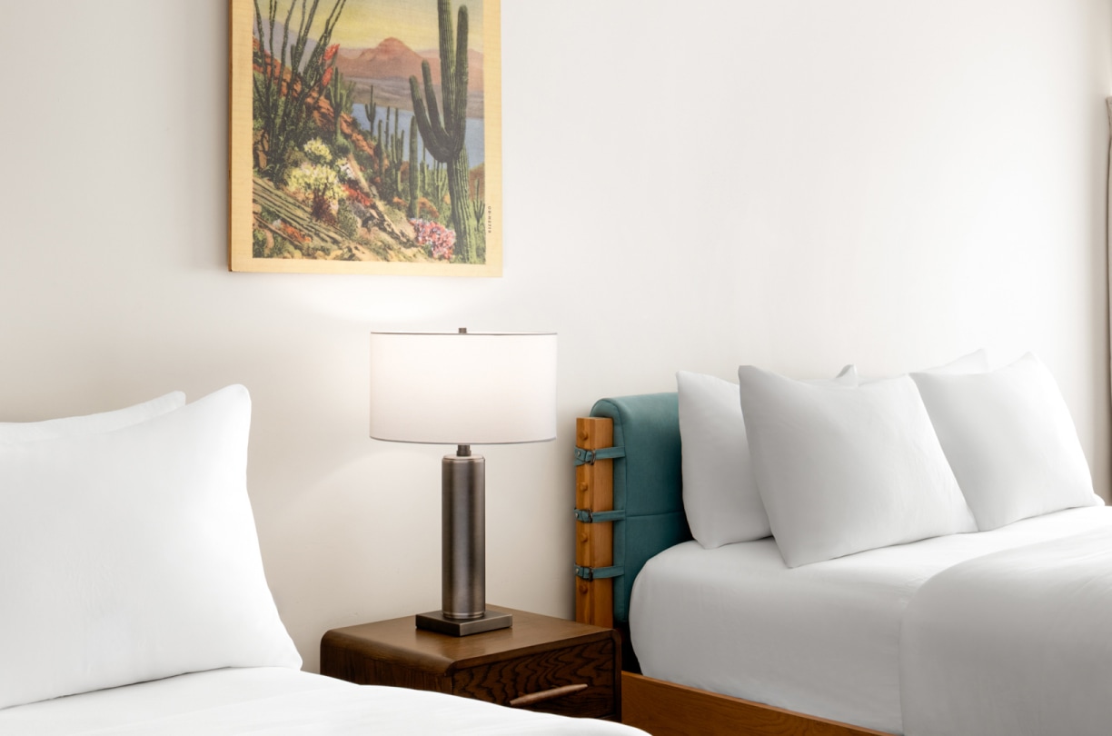 a bed with a lamp on a table