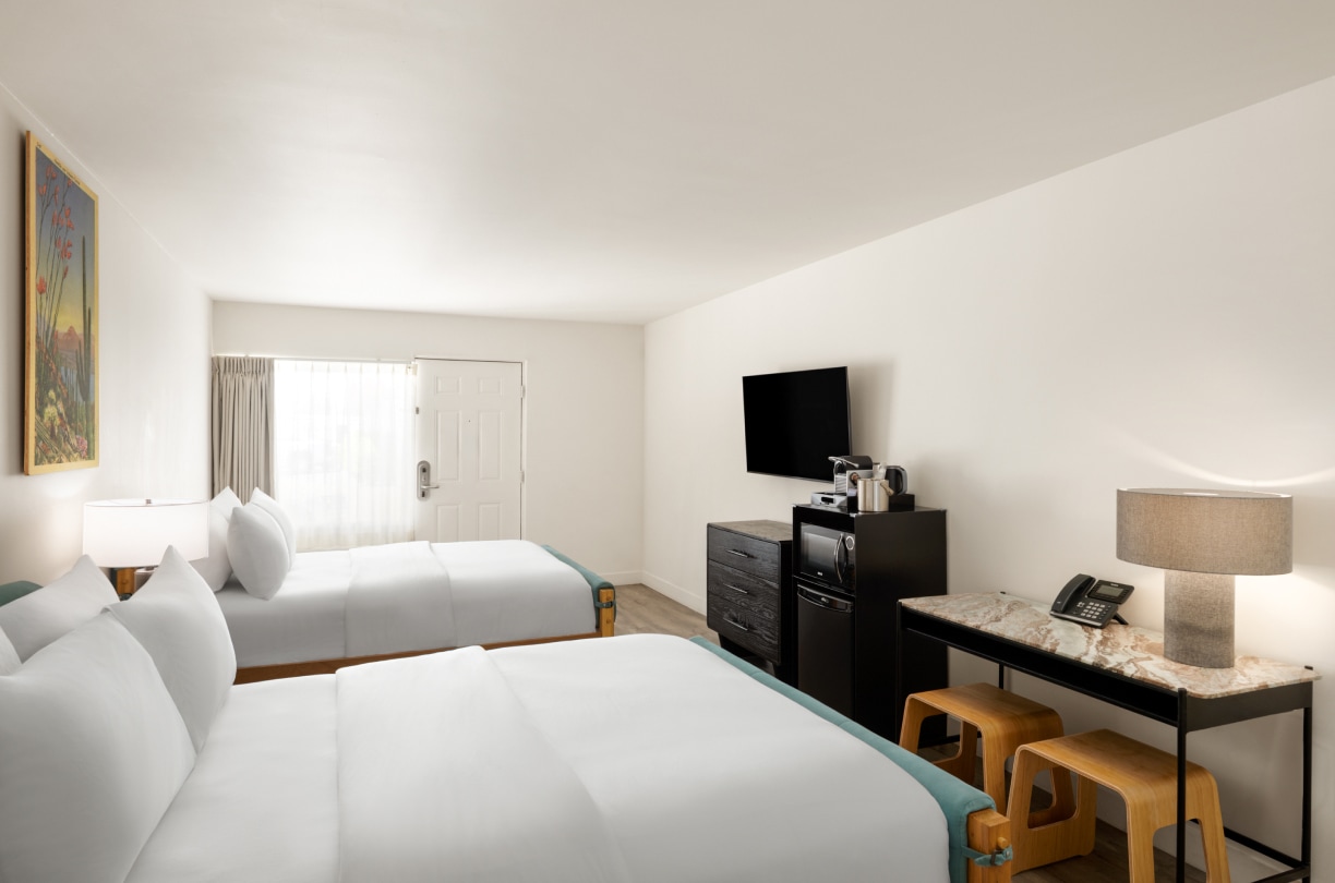 a room with two beds and a television