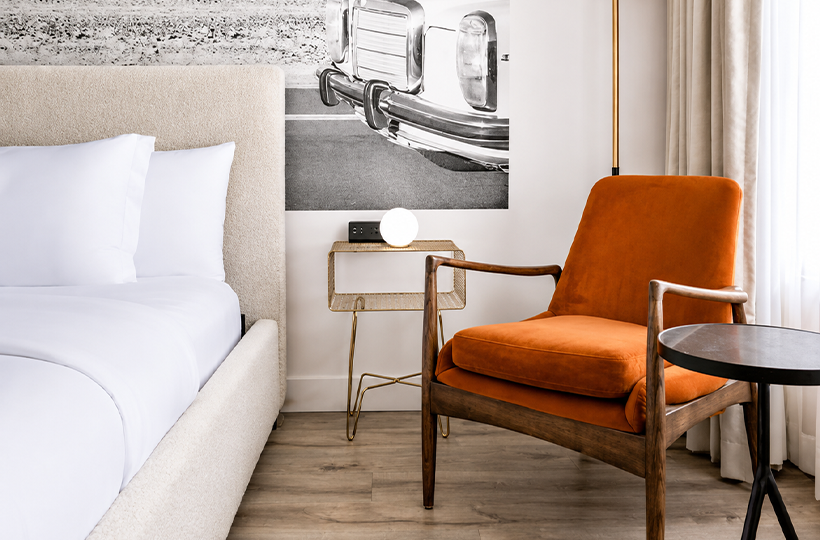 a chair next to a bed