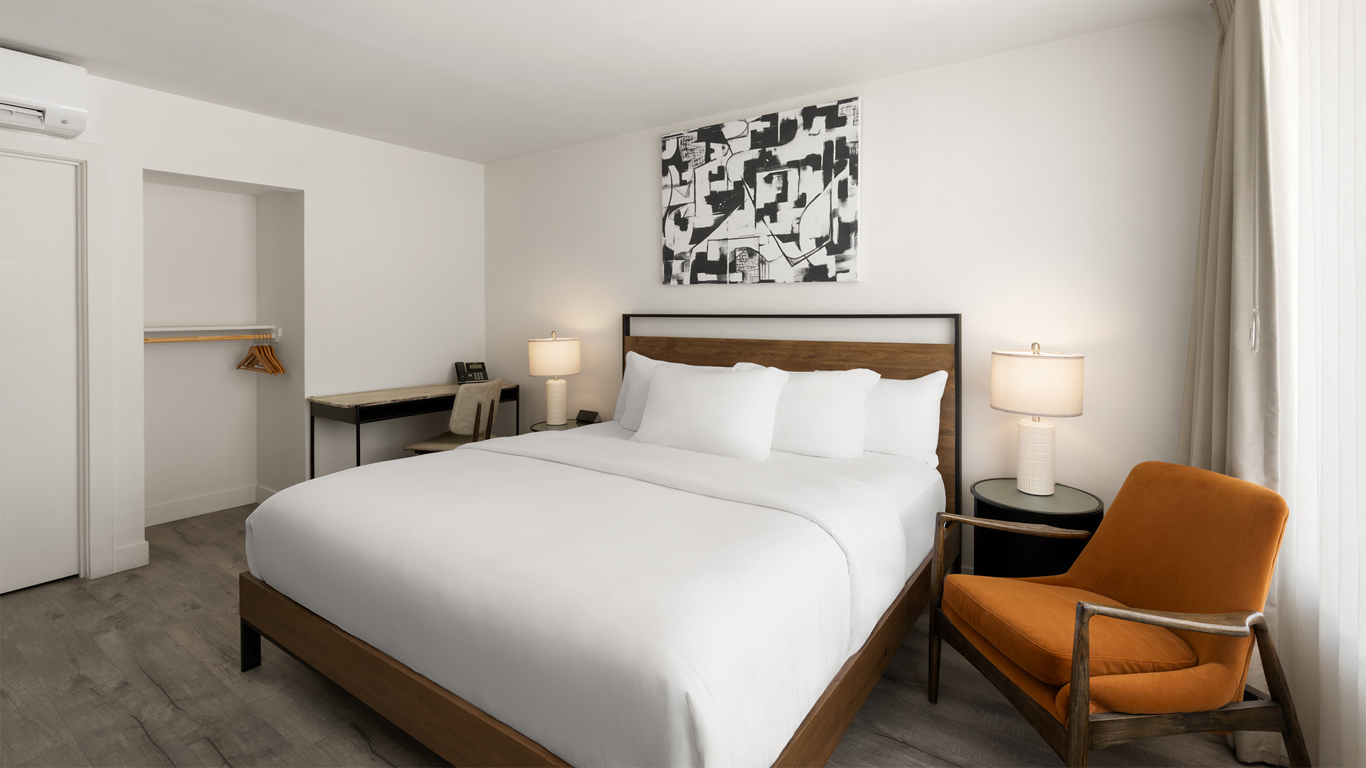 a bed with white sheets and a chair