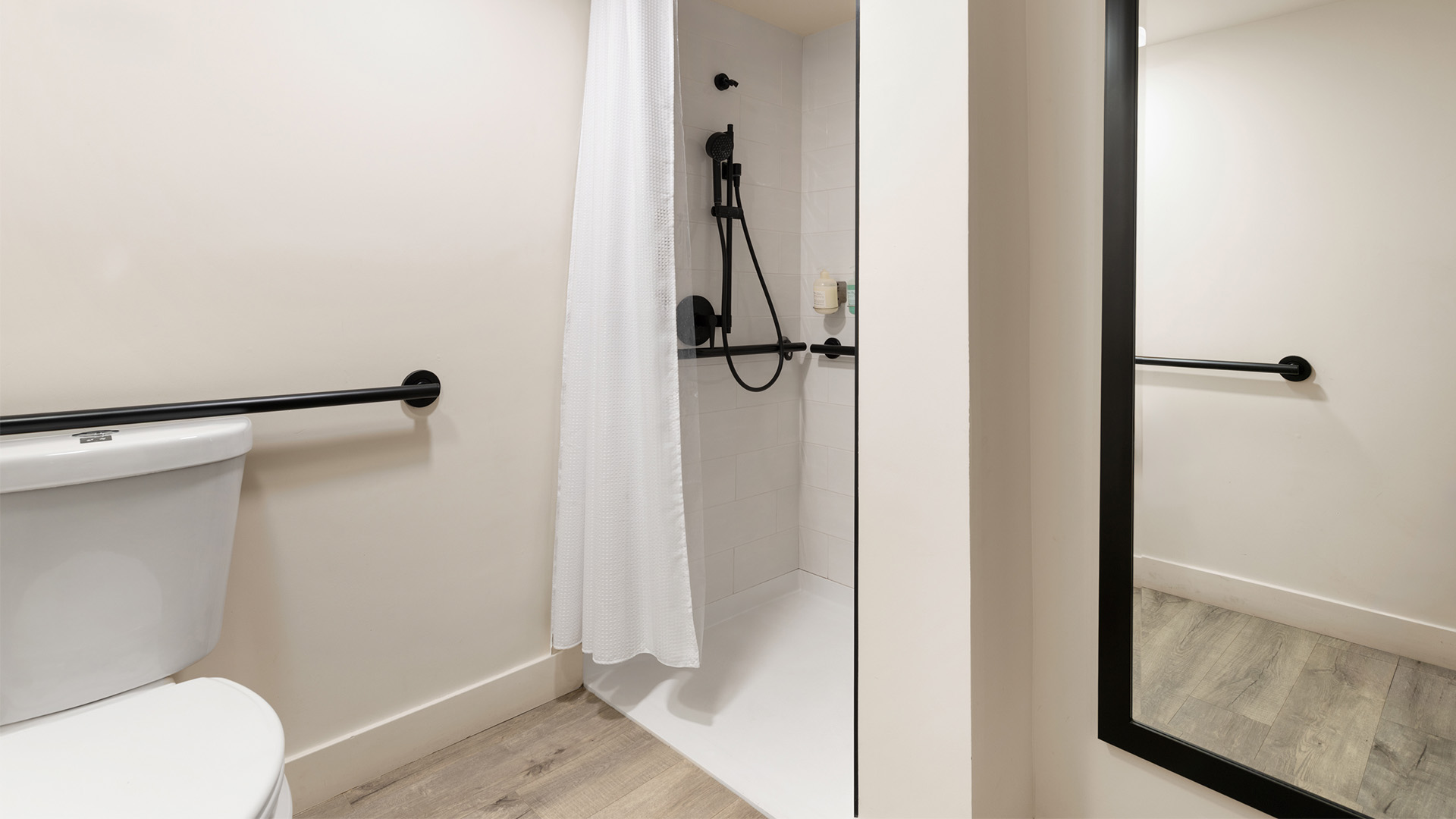 a shower with a white curtain