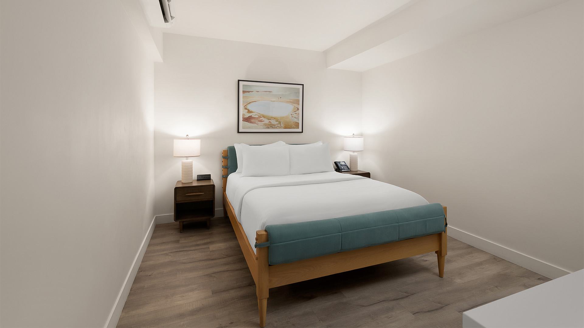 a bed with white sheets and a wood frame