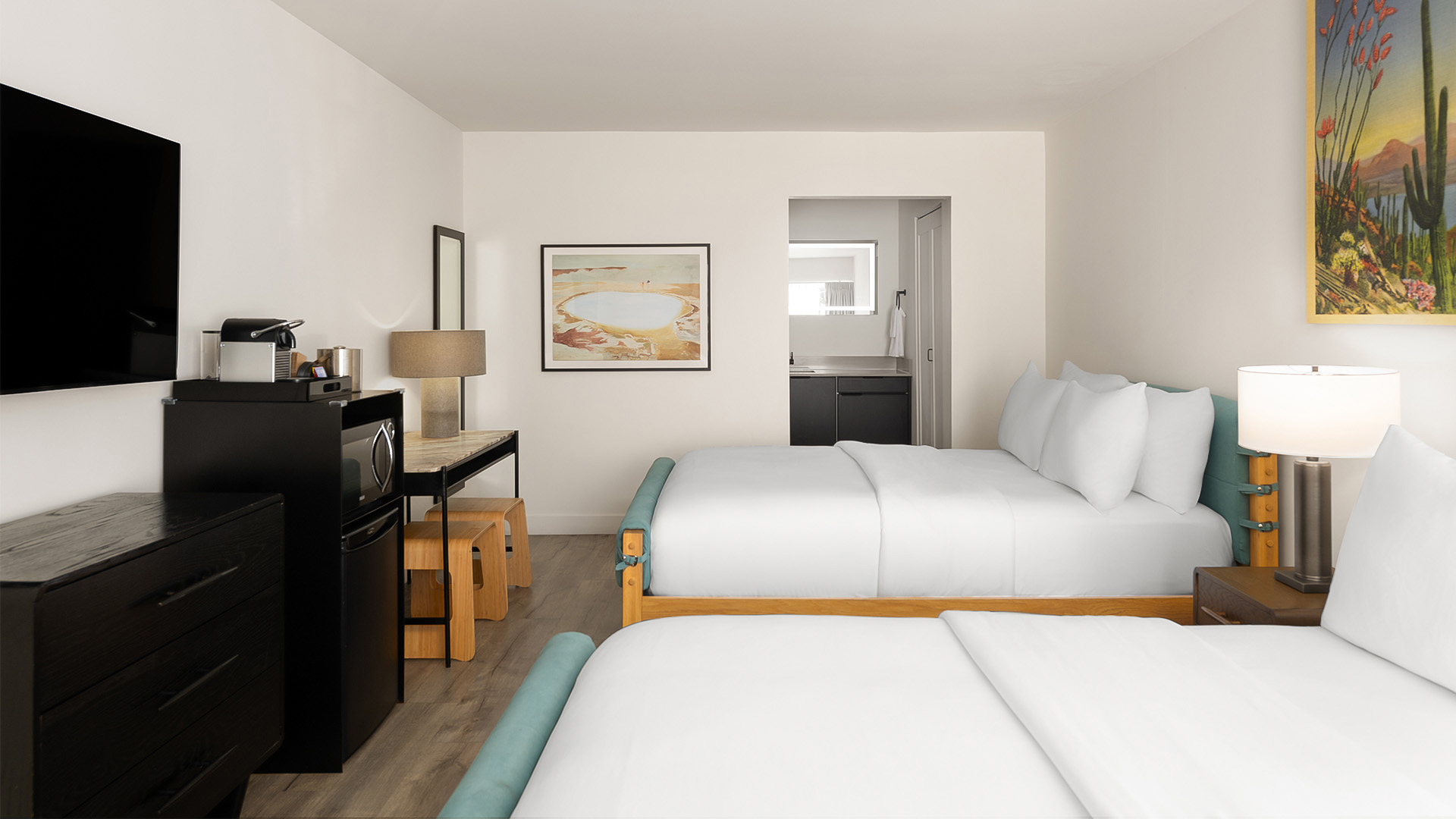 a room with two beds and a sink