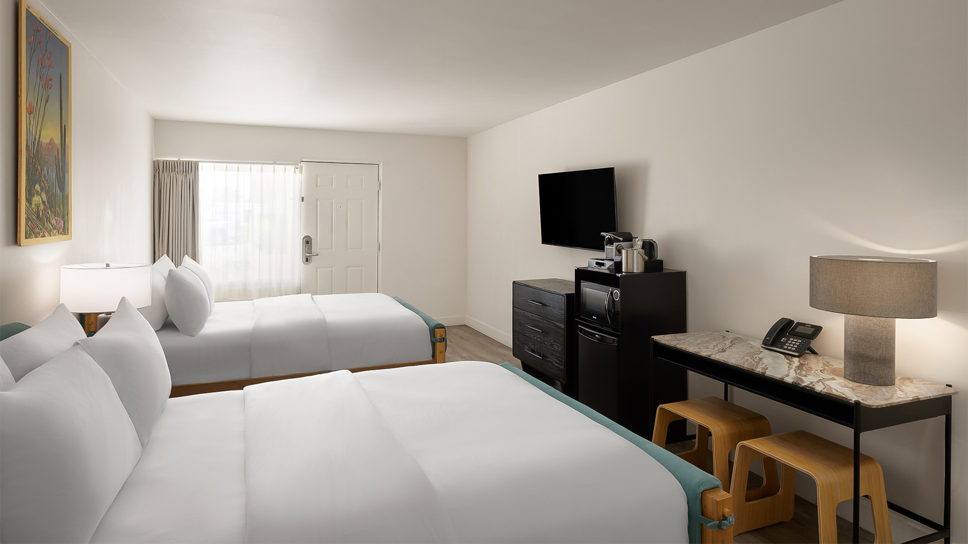 a room with two beds and a television