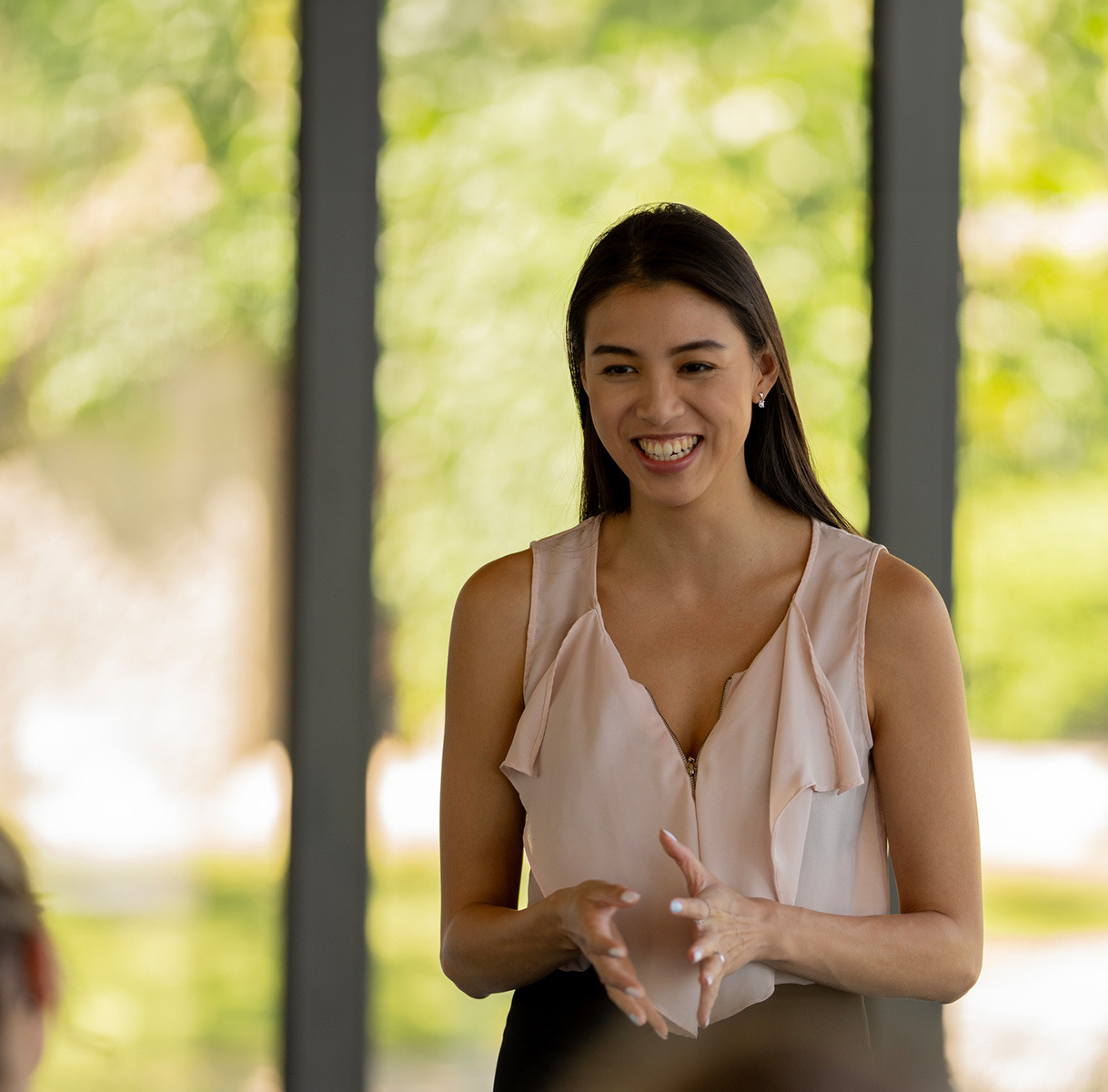 a woman smiling and talking