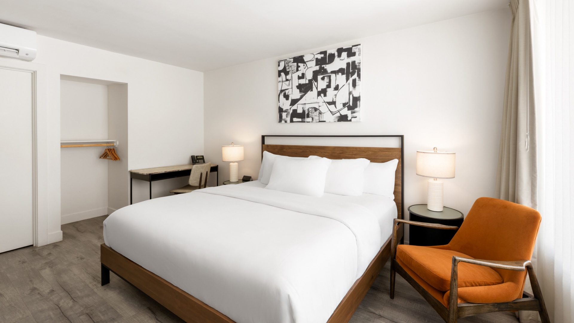 a bed with white sheets and a chair