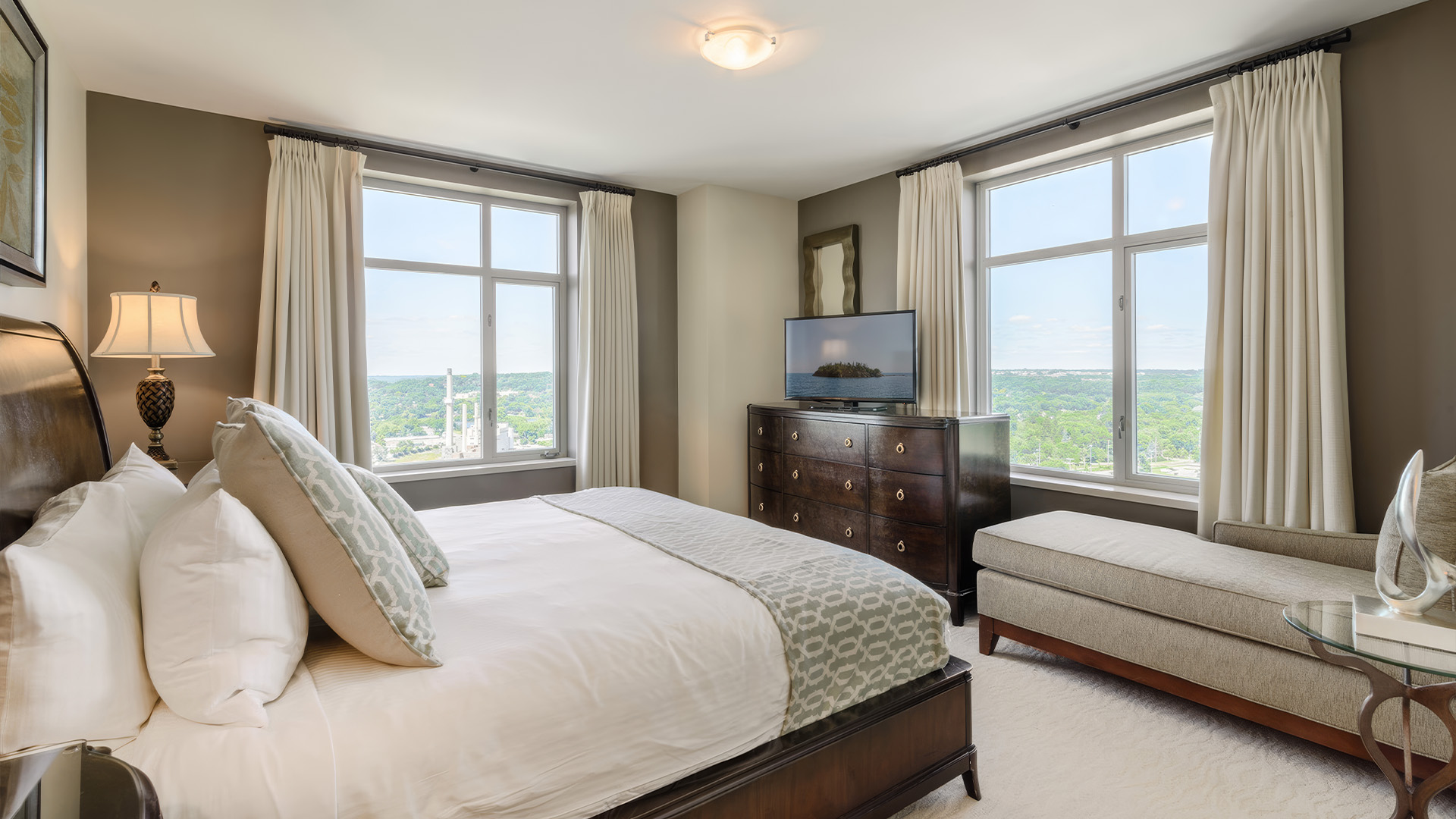 a bedroom with a large bed and a television