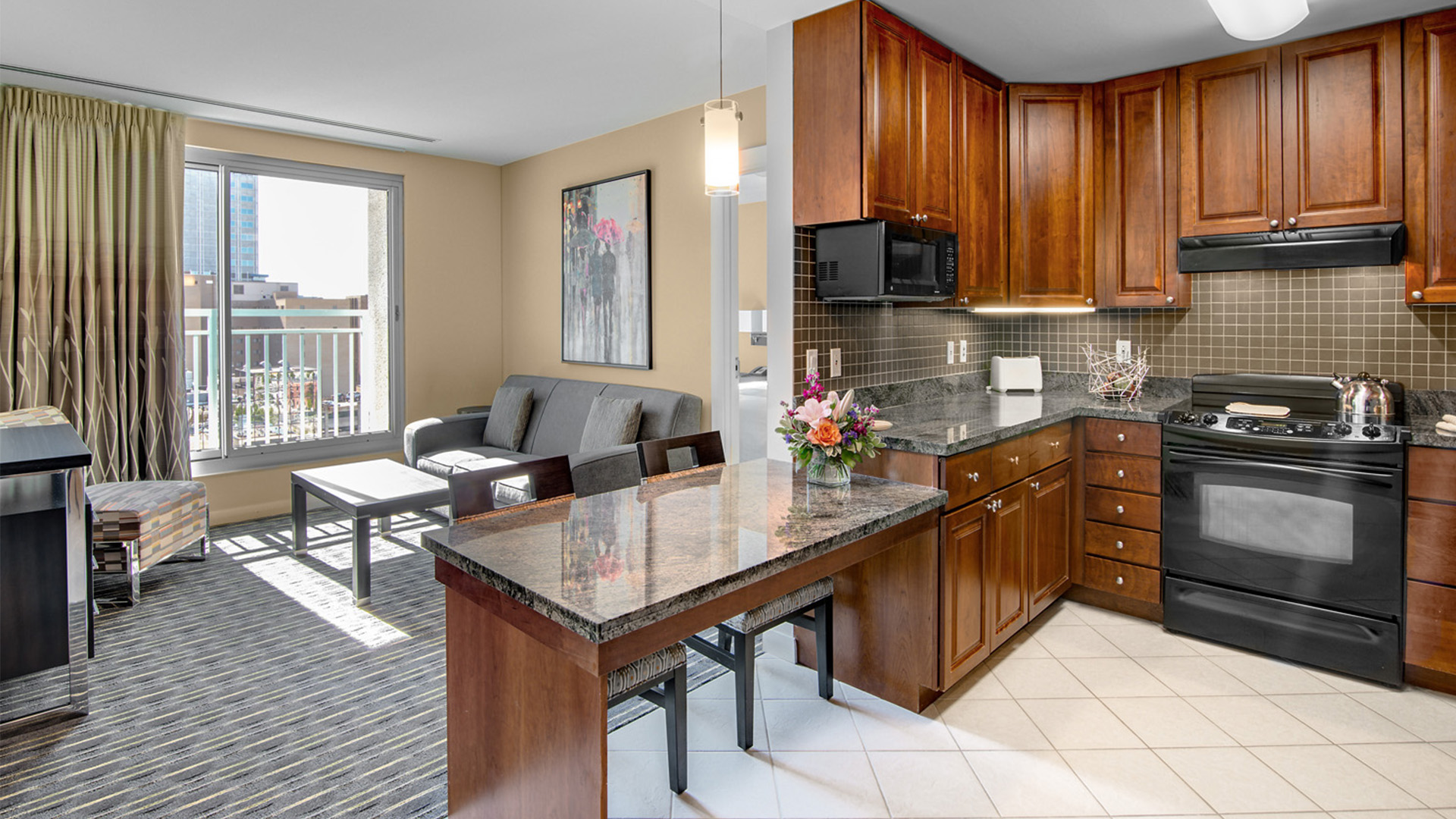 a kitchen and living room with a couch and a table