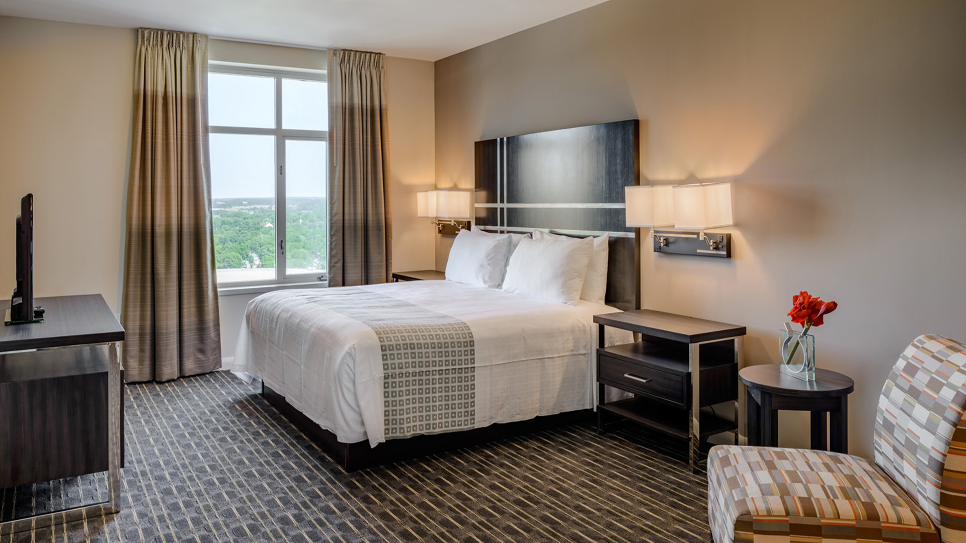 a hotel room with a bed and a window