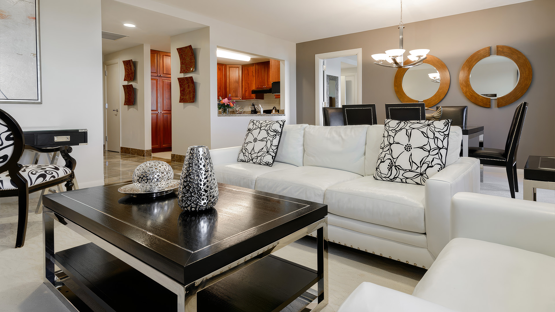 a living room with a white couch and black coffee table