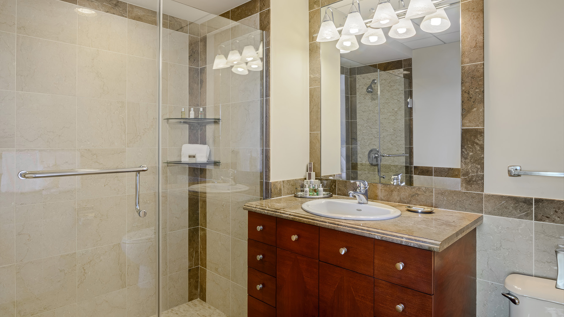 a bathroom with a glass shower and sink