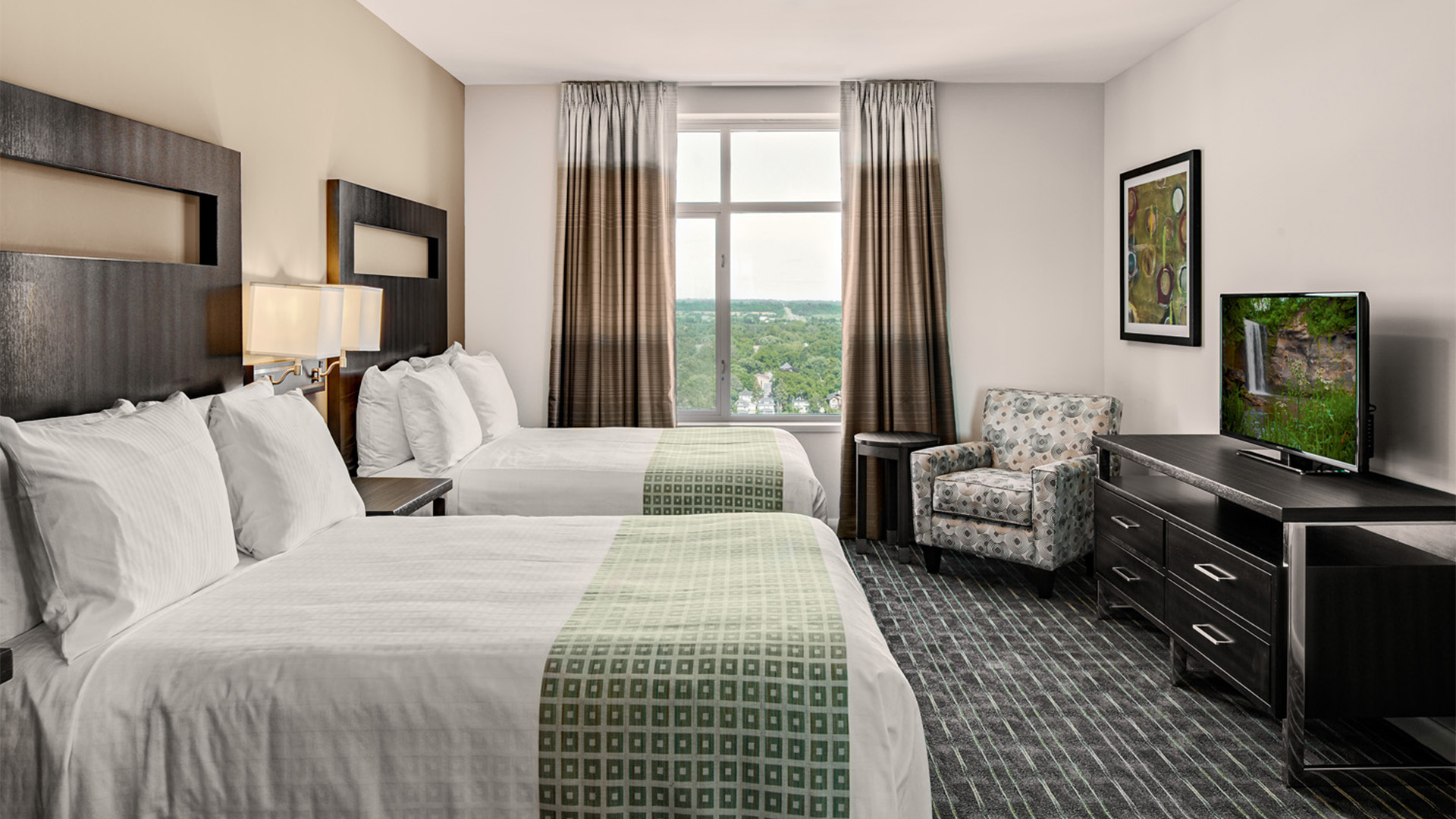 a room with two beds and a chair