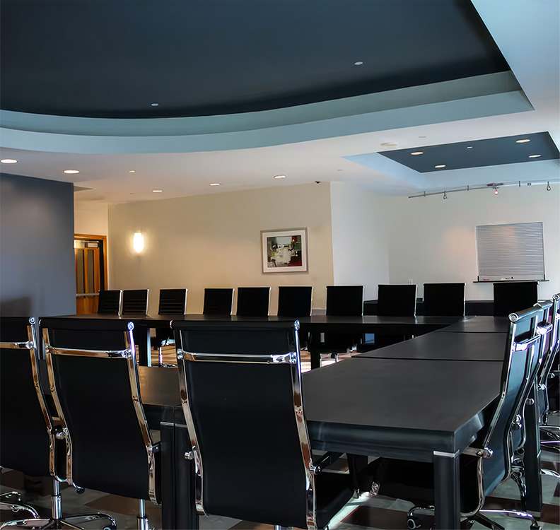 a conference room with black chairs and tables