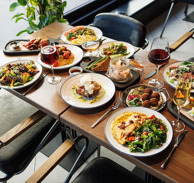a table with plates of food and wine