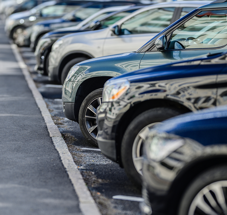a row of cars parked in a parking lot