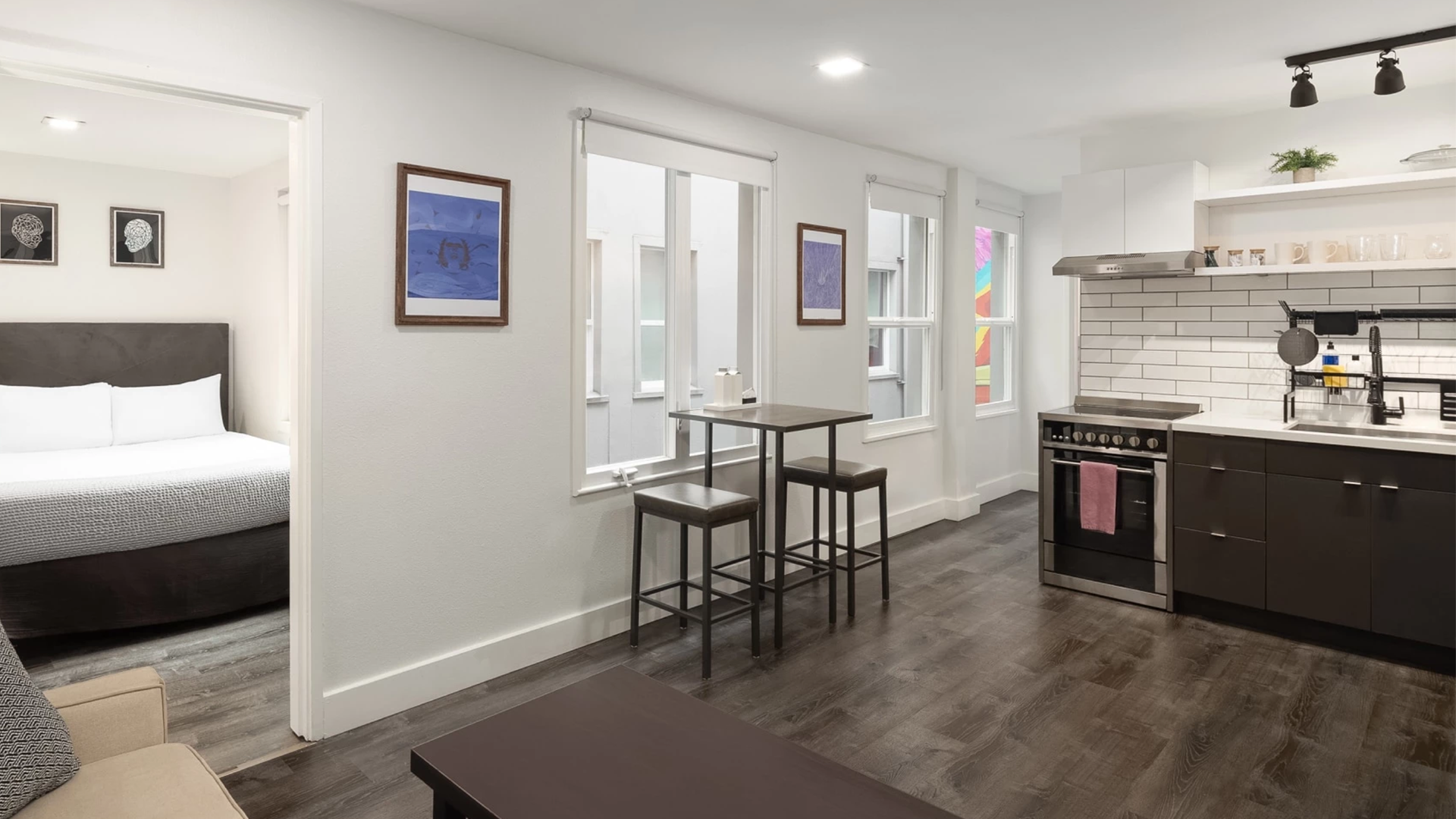 a kitchen with a table and stools