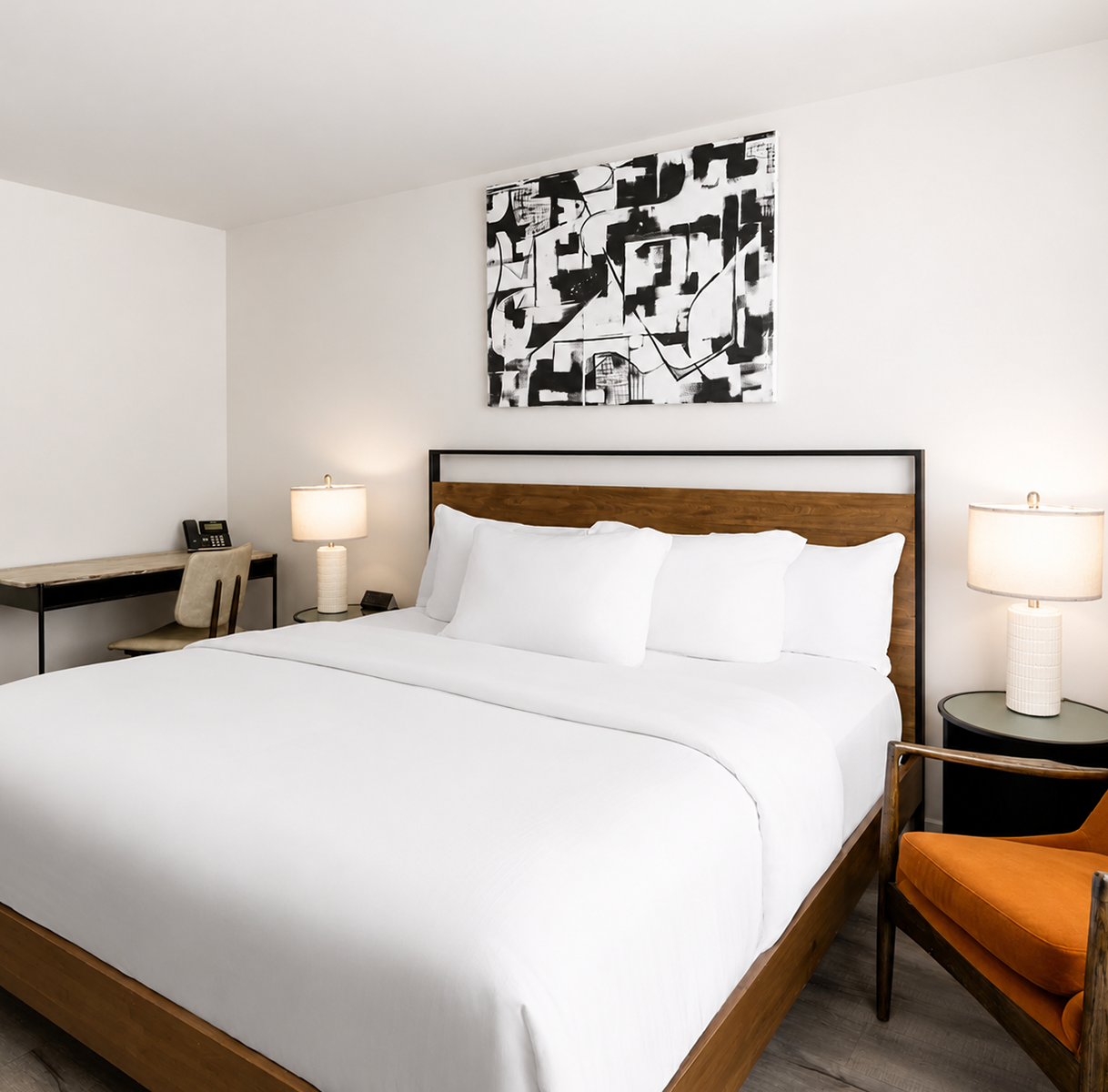 a bed with white sheets and a chair