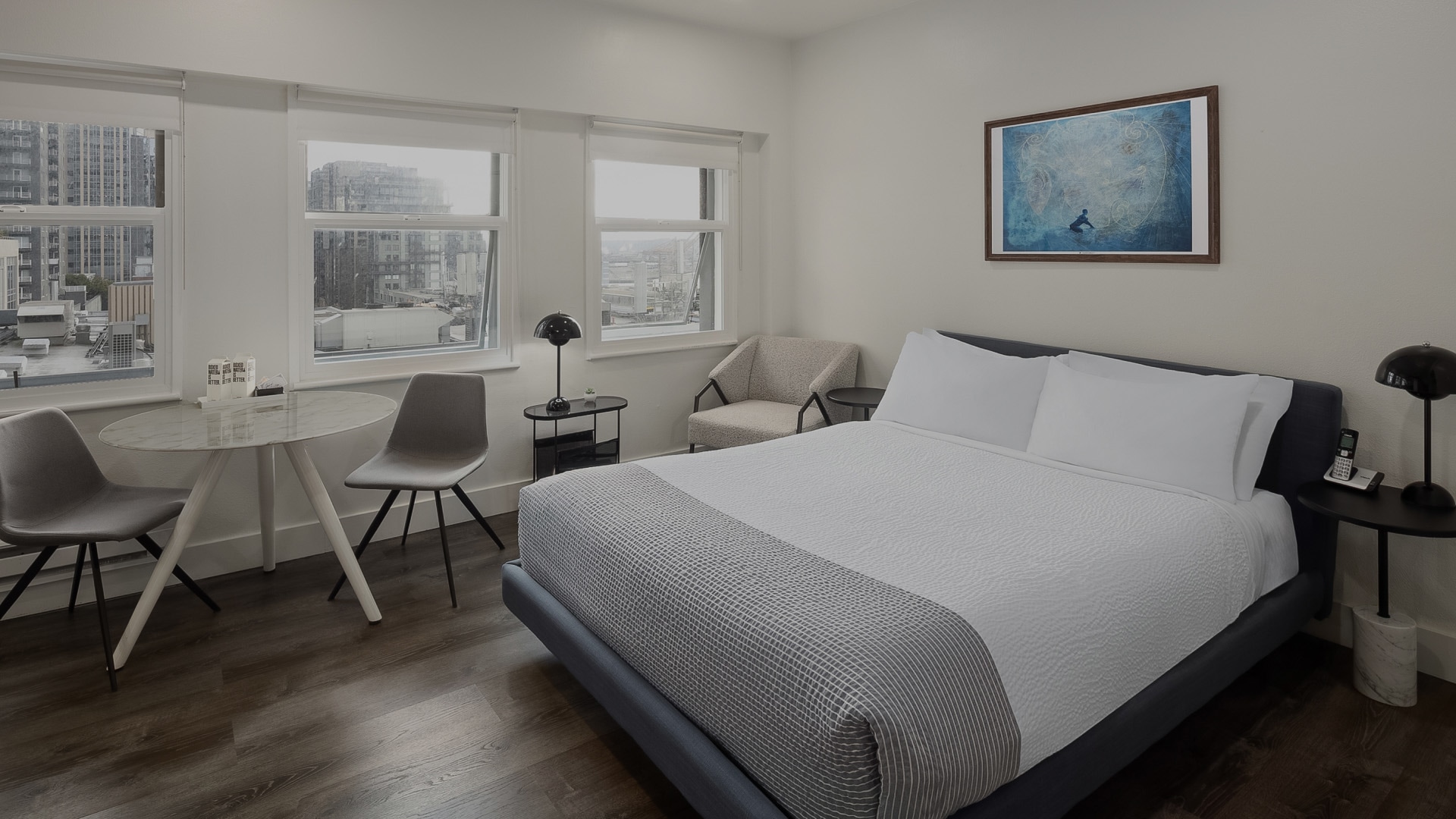a bedroom with a bed and chairs
